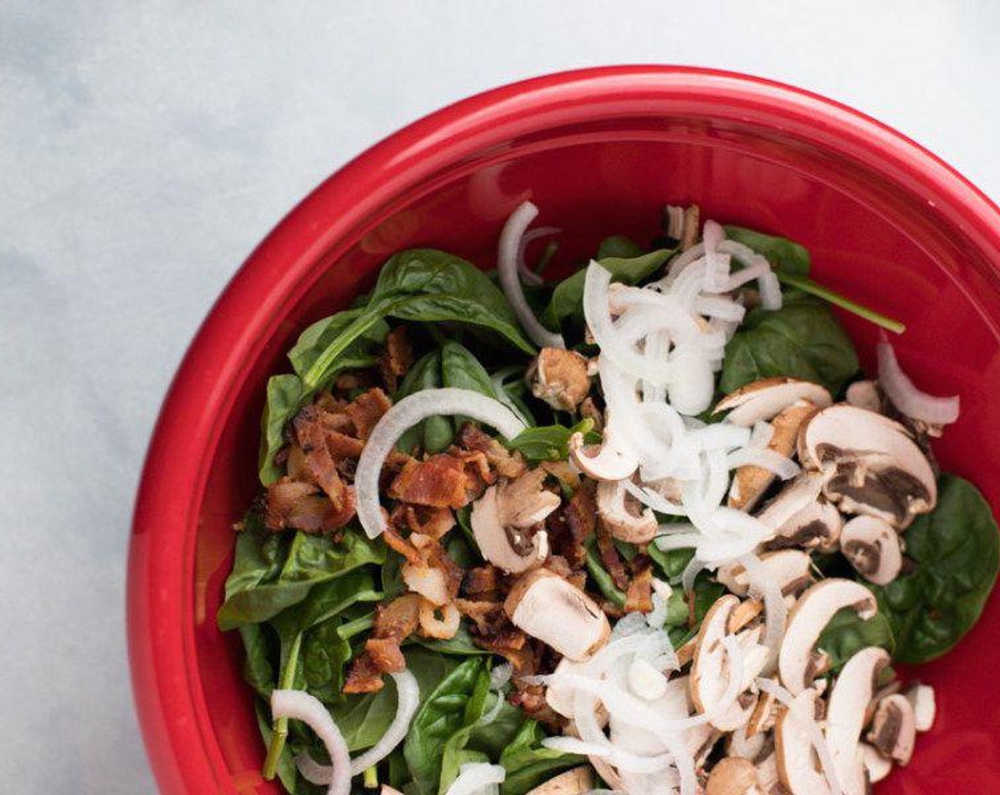 step 6 In a large bowl, combine the Fresh Baby Spinach (3 3/4 cups), Baby Bella Mushrooms (1 1/2 cups), White Onions (4 Tbsp), and bacon.