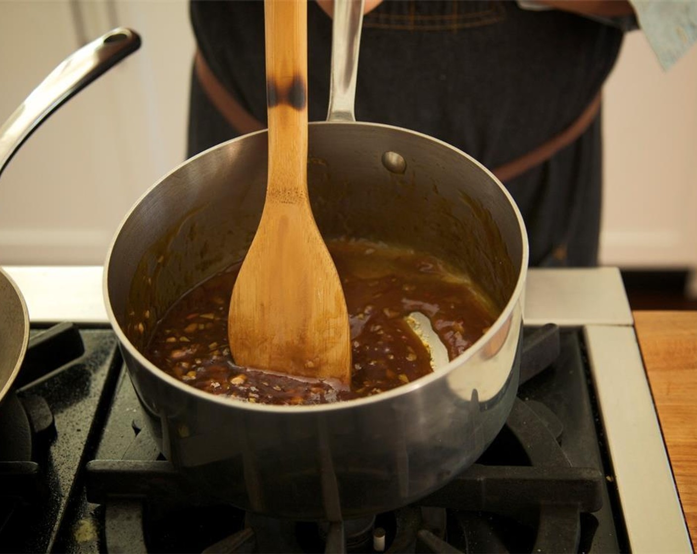 step 10 Using a whisk, slowly add the slurry to the sauce. Allow sauce to come to a boil again, thicken, and quickly remove from heat. Do not let burn! Set aside.