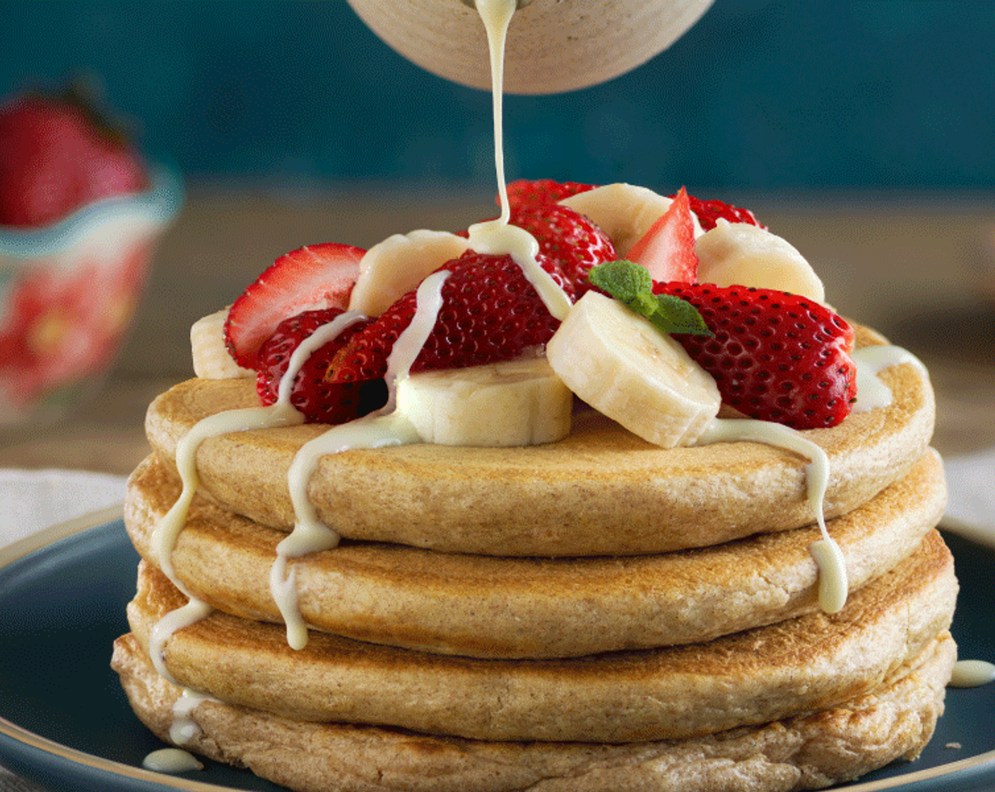 step 3 Serve the pancakes topped with Bananas (2), Fresh Strawberries (8), and Sweetened Condensed Milk (4 Tbsp).