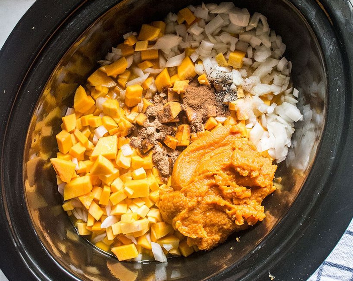 step 1 Add Butternut Squash (7 cups), Vegetable Broth (3 cups), 100% Pumpkin Purée (1 cup), Sweet Onion (1 cup), Garlic (1 clove), Coconut Sugar (2 Tbsp), Sea Salt (1 tsp), Ground Black Pepper (1/2 tsp), Simply Organic Cinnamon, Ground (1 tsp) and Ground Nutmeg (1/8 tsp) to crockpot. Stir and cook on low 4-5 hours, or high 2-3 hrs.