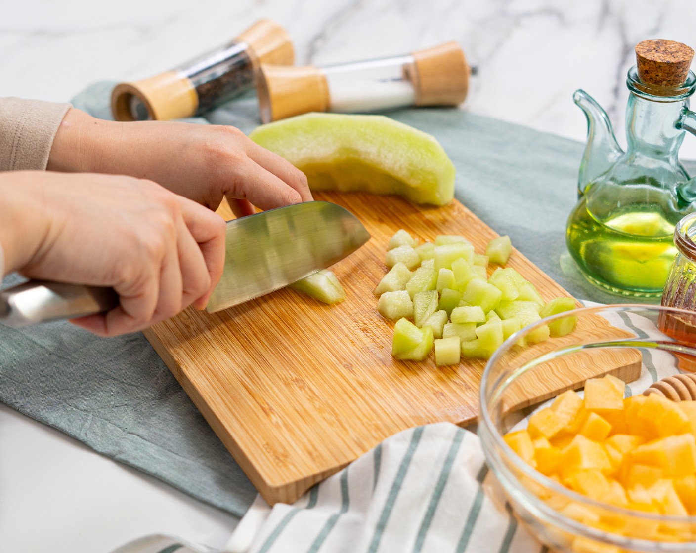 step 1 Cut Cantaloupe (1/4) and Honeydew Melon (1/4) into bite-size cubes. Set aside.