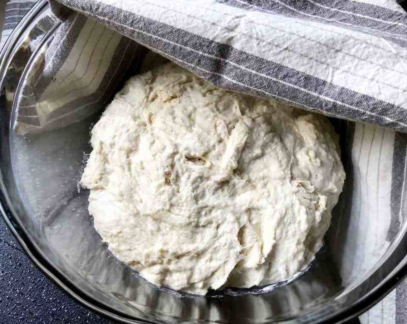 step 3 Cover with a non-airtight lid. Allow the dough to rise at room temperature until it begins to flatten on top, about 2 hours. Do not punch down the dough! With this method, you're trying to retain as much gas in the dough as possible.