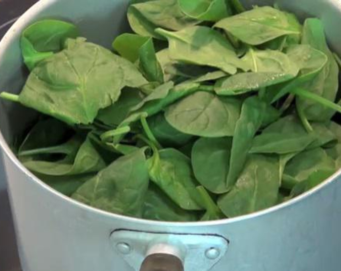 step 2 After the onions are softened, add the Spinach Leaves (2 bunches). Stir for about 6 minutes until everything is mixed well. After six minutes, turn the heat off and transfer the spinach to a strainer so that excess liquid will drain off.