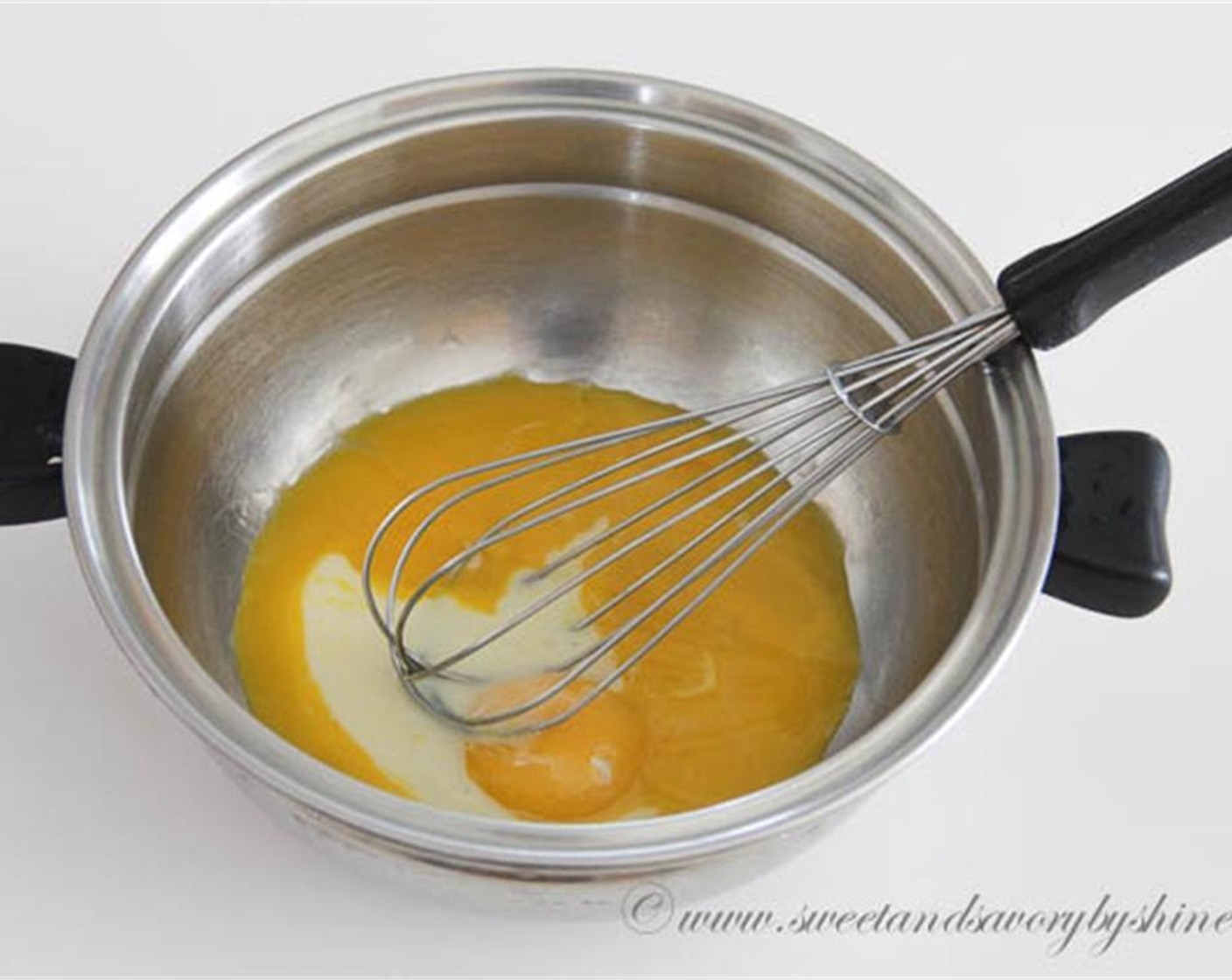 step 2 In a medium bowl, beat the yolks of the Eggs (4) and remaining Sweetened Condensed Milk (1/4 cup) until pale.