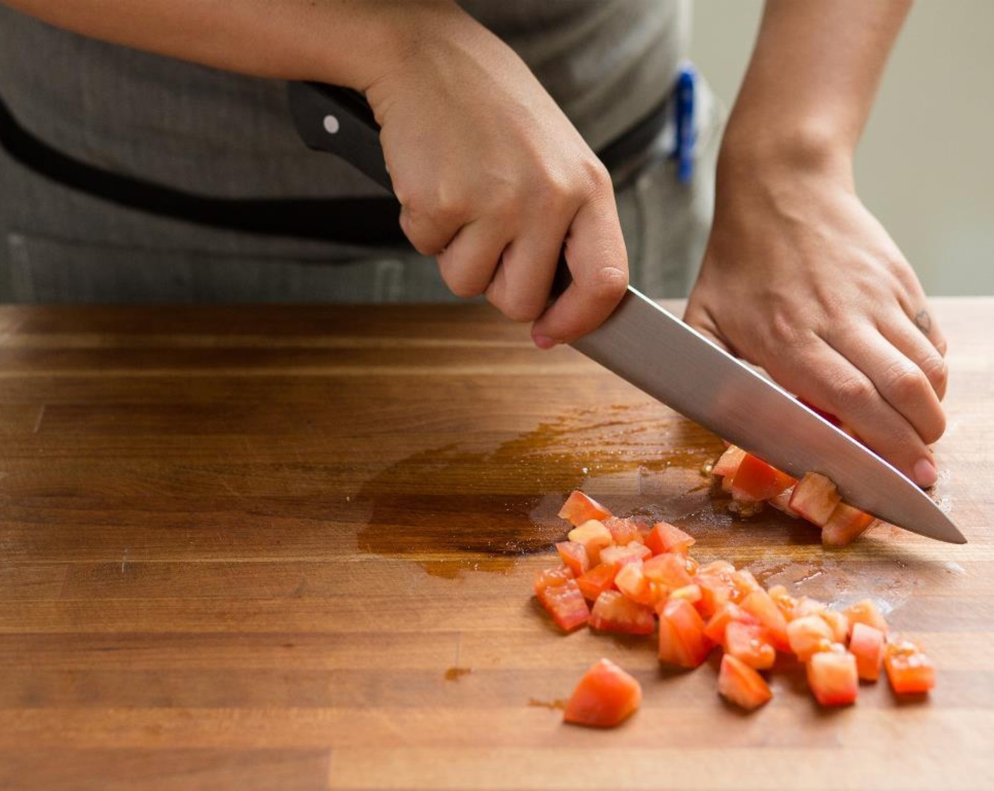 step 1 Cut the Roma Tomato (1) into 1/2-inch diced pieces and place in a medium bowl.