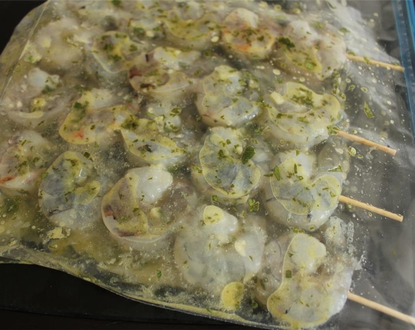 step 4 Place the shrimp skewers in a large Ziploc bag and pour the remaining marinade over them. Seal the bag, removing any excess air, and refrigerate for at least 30 minutes.