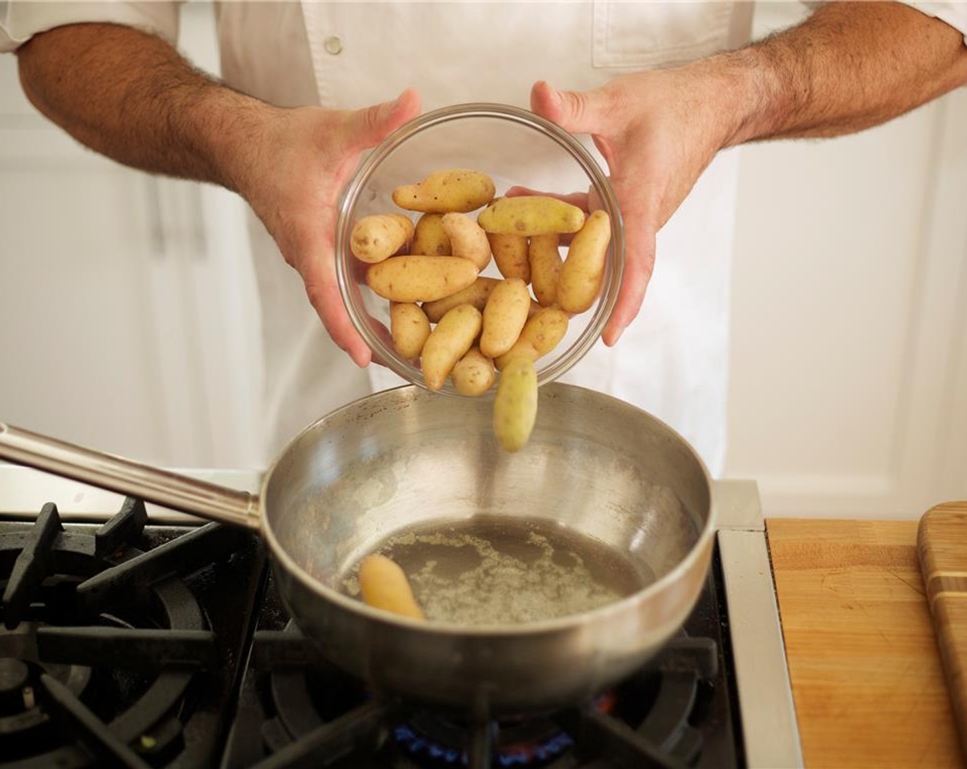 step 8 Add 2 pats of Butter (to taste) to a large 3 inch deep saute pan over medium heat. When melted, add the Fingerling Potatoes (2 1/4 cups) with 1/4 teaspoon salt and 1/4 teaspoon pepper. Stir, cover and reduce heat to low. Cook for 20 to 30 minutes until potatoes are fork tender.