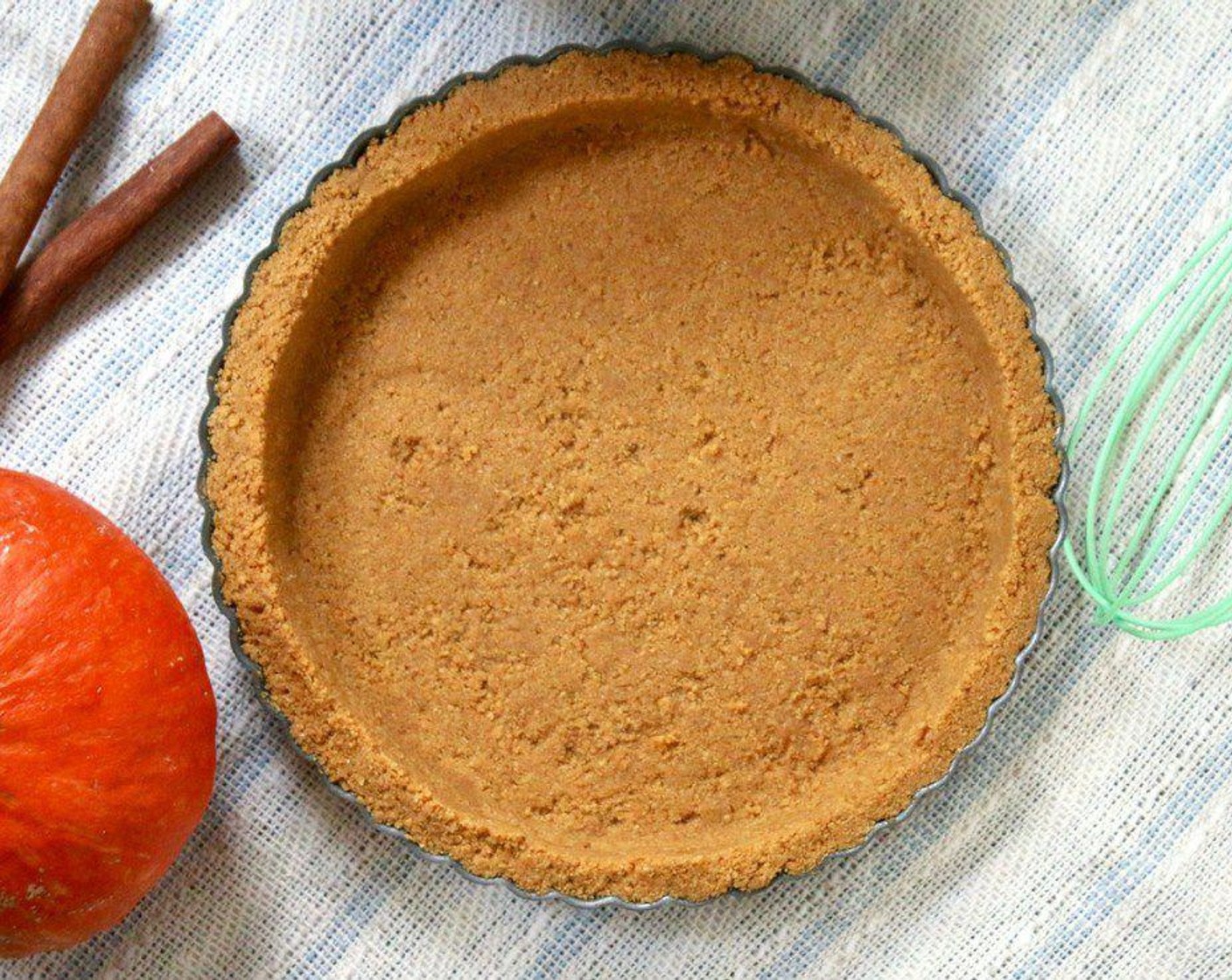 step 3 Pour the crust mixture into a 9-inch tart pan and press into an even layer using the bottom of a greased cup or your hands. Place in fridge until ready to fill.