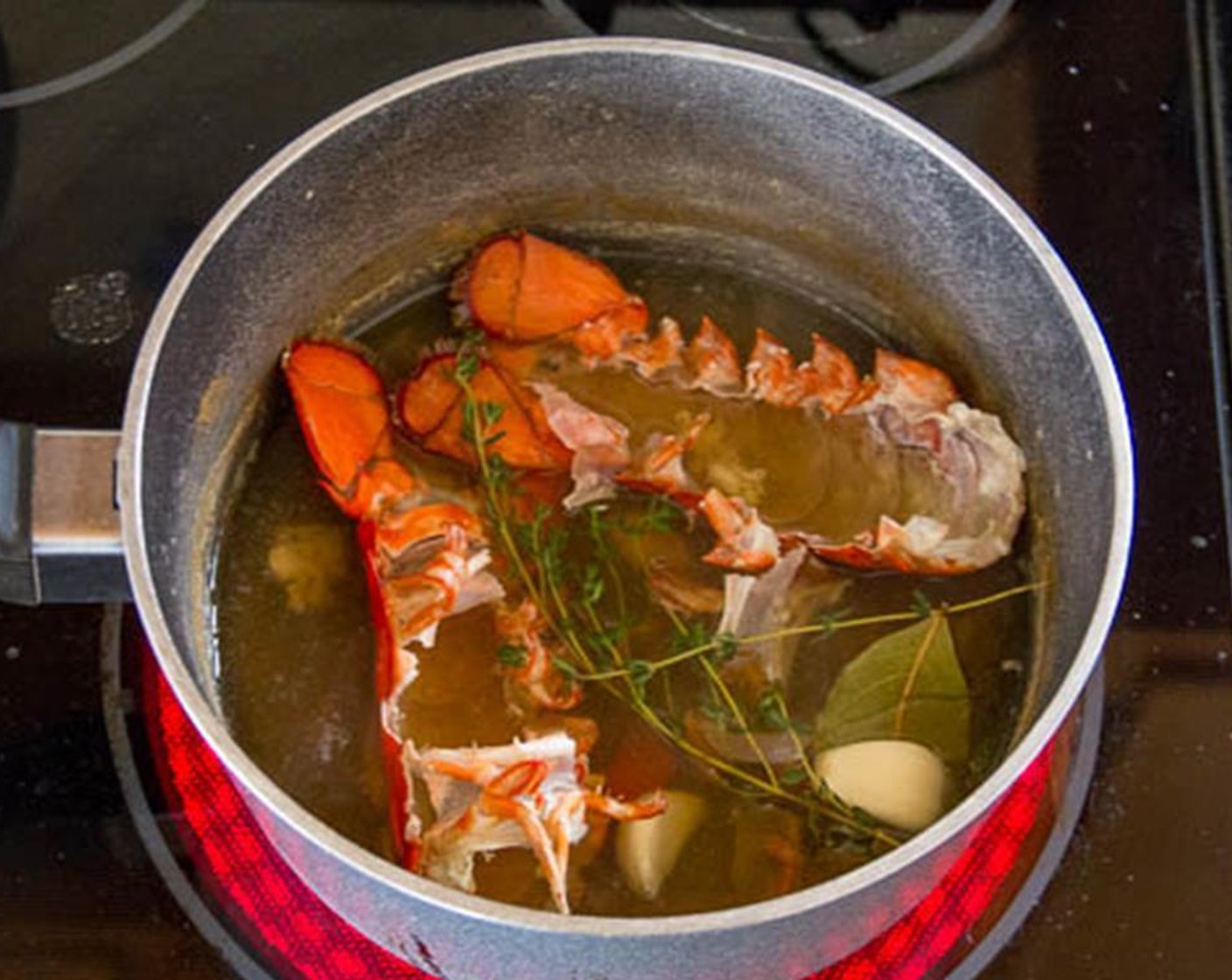 step 3 Put the shells back into the water. Add Garlic (2 cloves), Bay Leaf (1), and Fresh Thyme (2 sprigs). Increase the heat to medium high and boil until the broth is reduced to about ½ cup, about 25 minutes.