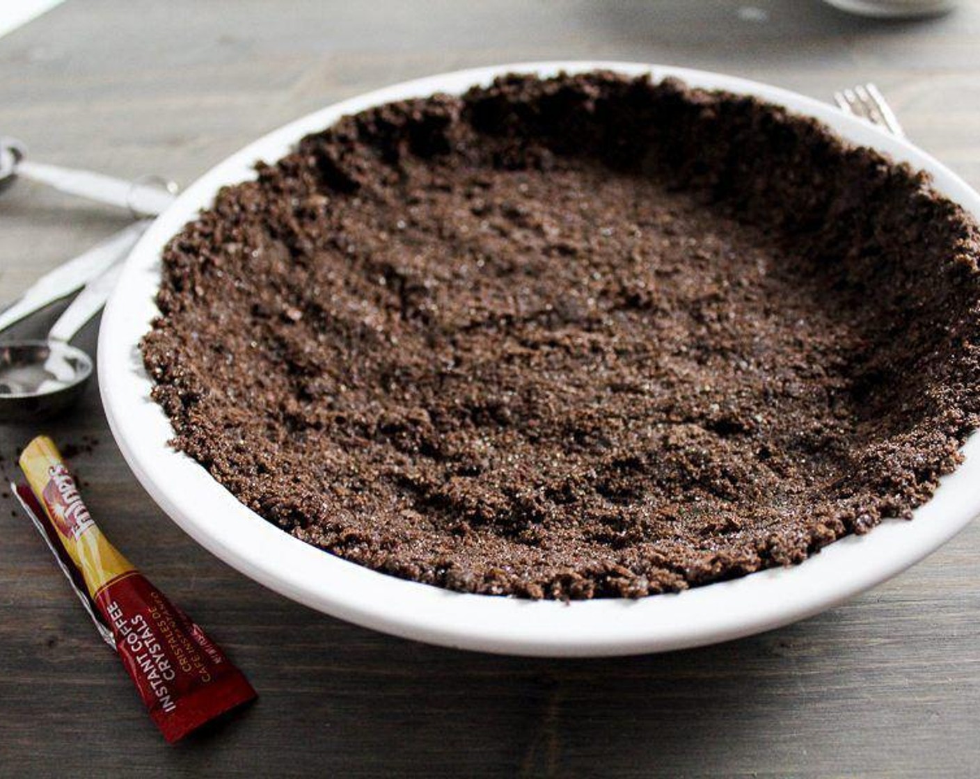 step 3 Press the mixture firmly and evenly into the bottom of the pie dish. Refrigerate while preparing the pie filling.