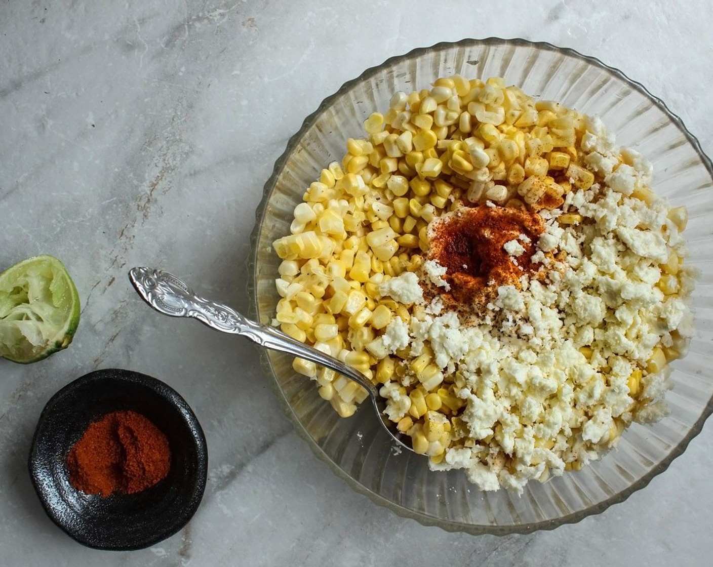 step 5 Squeeze the Lime (1/4) over the corn. Add in the Cayenne Pepper (1 tsp), Mayonnaise (2 1/2 Tbsp) and Granulated Sugar (1/2 Tbsp) if corn is not sweet. Mix well.