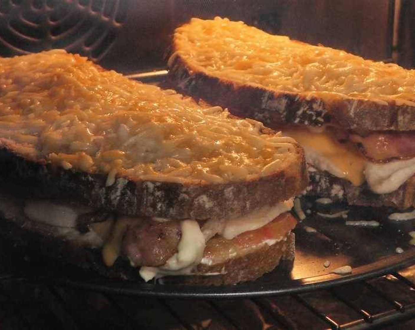 step 5 Finally place the top slice of bread and cover the top with a good amount of Shredded Cheese (to taste). Place in the oven on the broil setting long enough for the cheese to melt and toast the bread slightly.