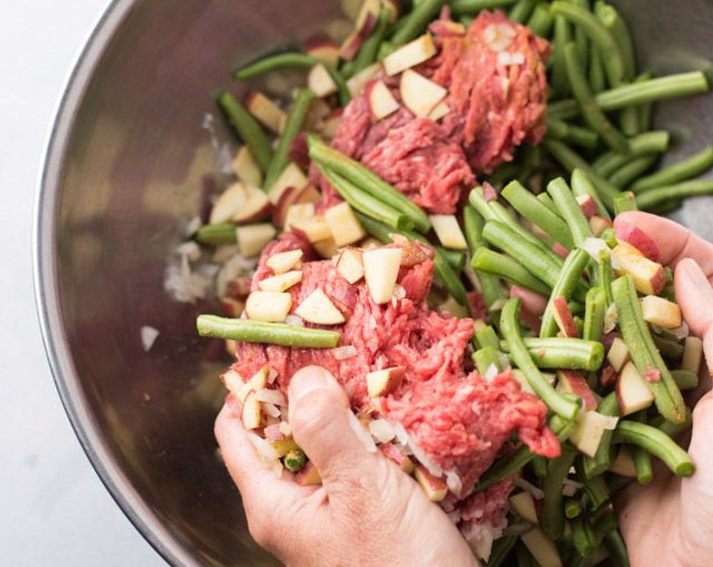 step 1 Prepare and measure out all ingredients. In an extra-large mixing bowl, combine the 90/10 Lean Ground Beef (1 lb), Red Potatoes (2 cups), Green Beans (4 cups), Onion (1/2 cup), Egg (1), Salt (1 tsp), Ground Cumin (1 tsp) and Freshly Ground Black Pepper (1/4 tsp) together with your hands.