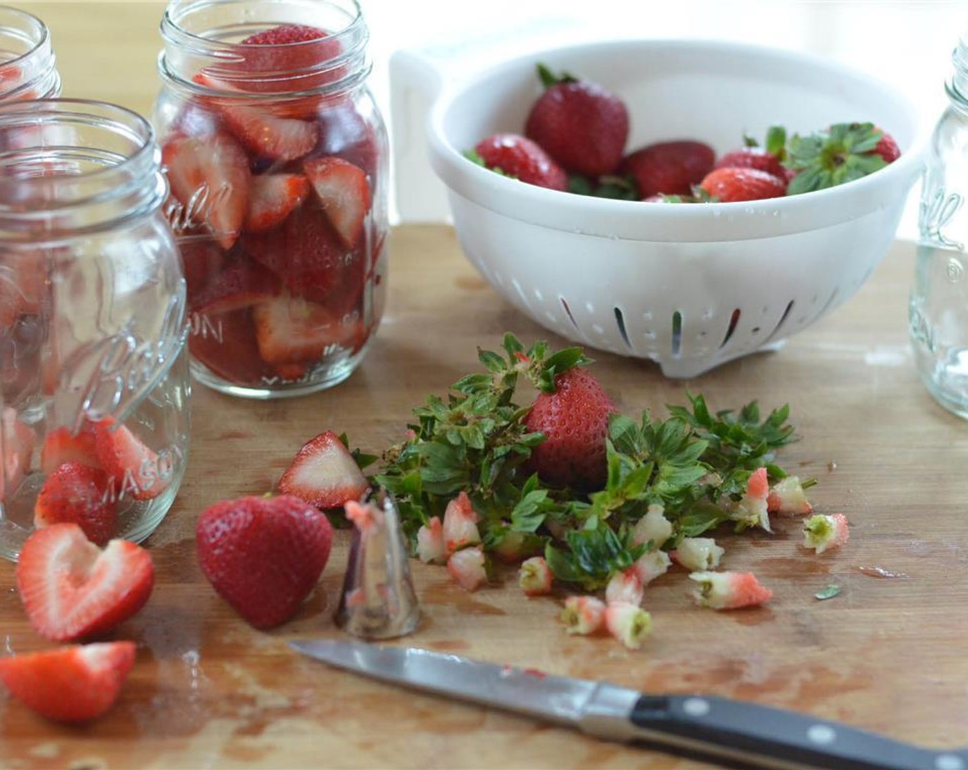step 2 Remove the stems and cut the strawberries into quarters.