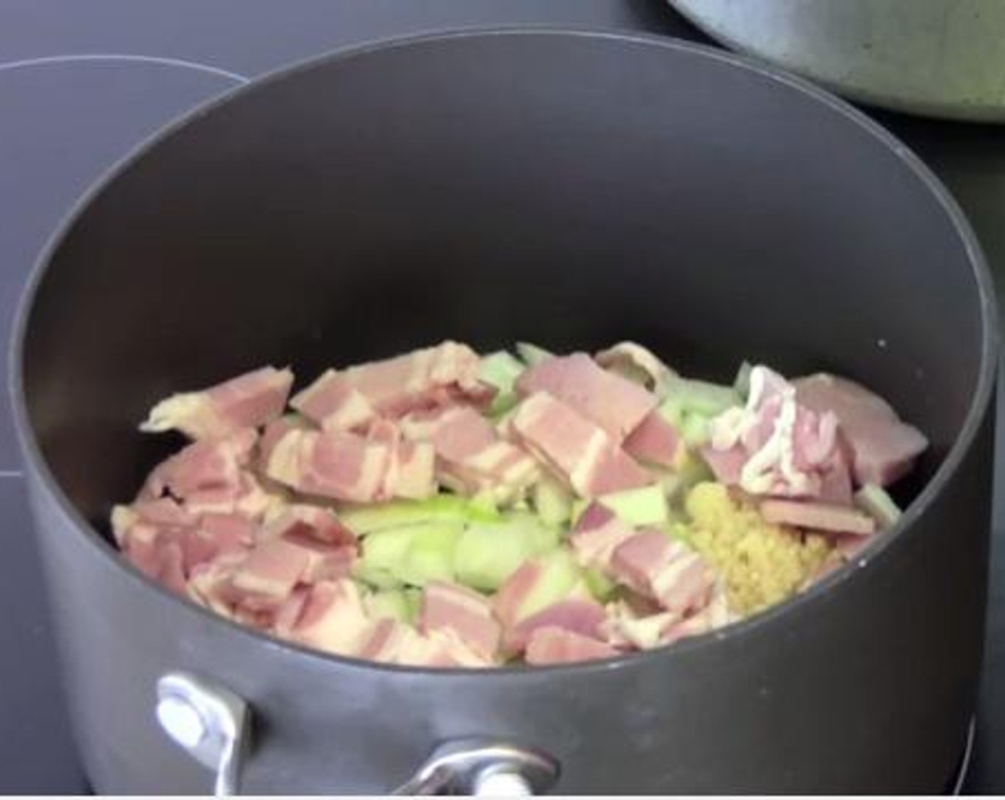 step 2 Into a small pan with some Olive Oil (as needed) cook together the Yellow Onion (1), Garlic (2 cloves), and Bacon (5.5 oz) over medium heat.