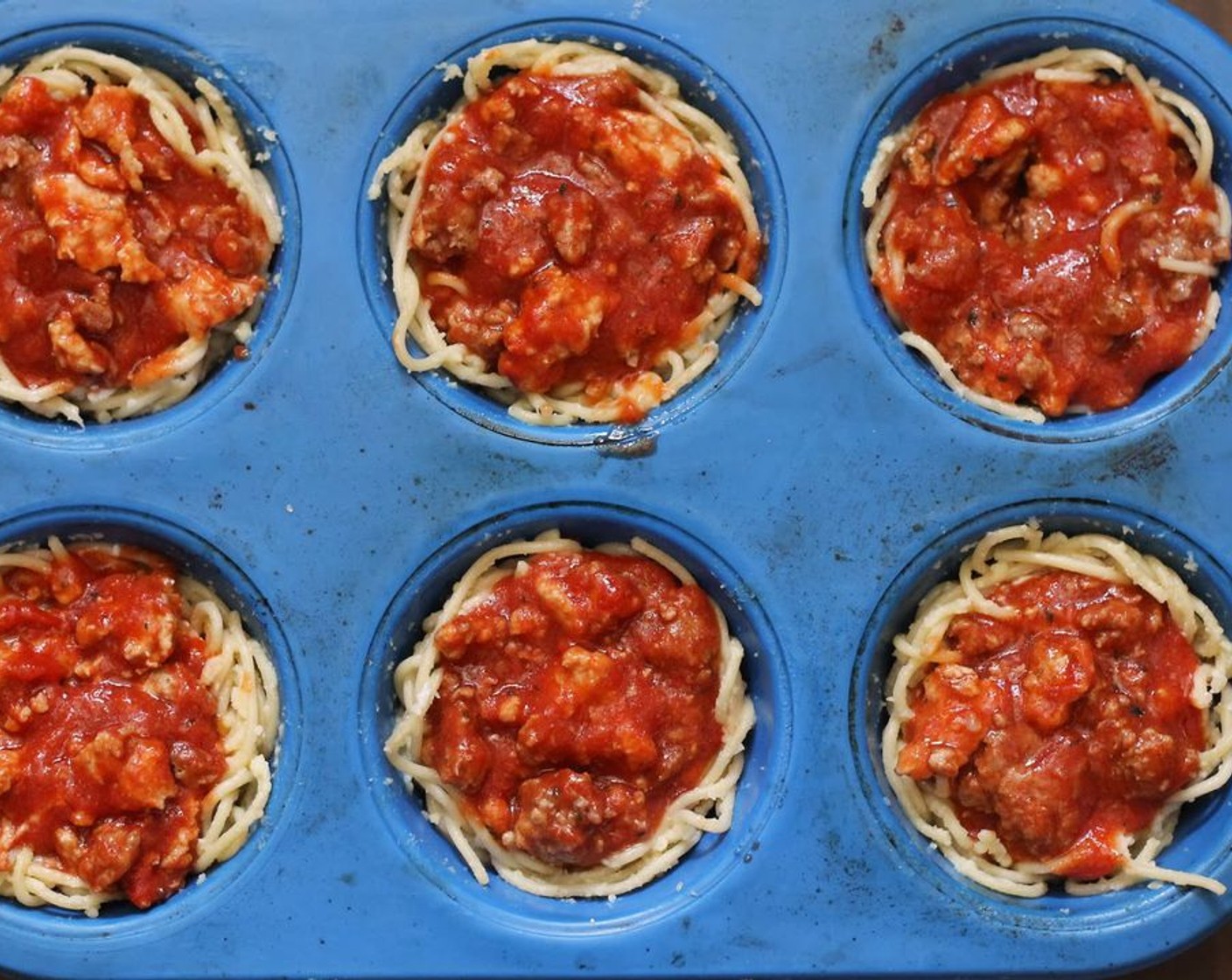 step 11 Spoon the sauce mixture evenly over spaghetti nests.