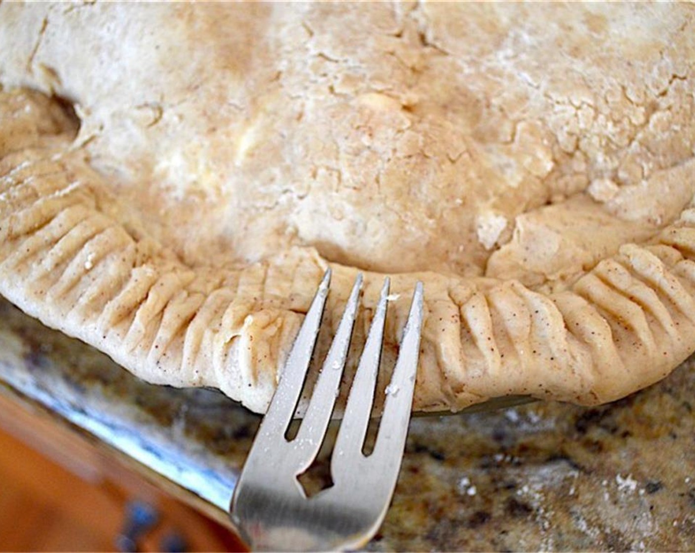 step 9 Crimp the edges of the bottom crust and top crust together, then make the edge pretty by pressing it with the tines of a fork.