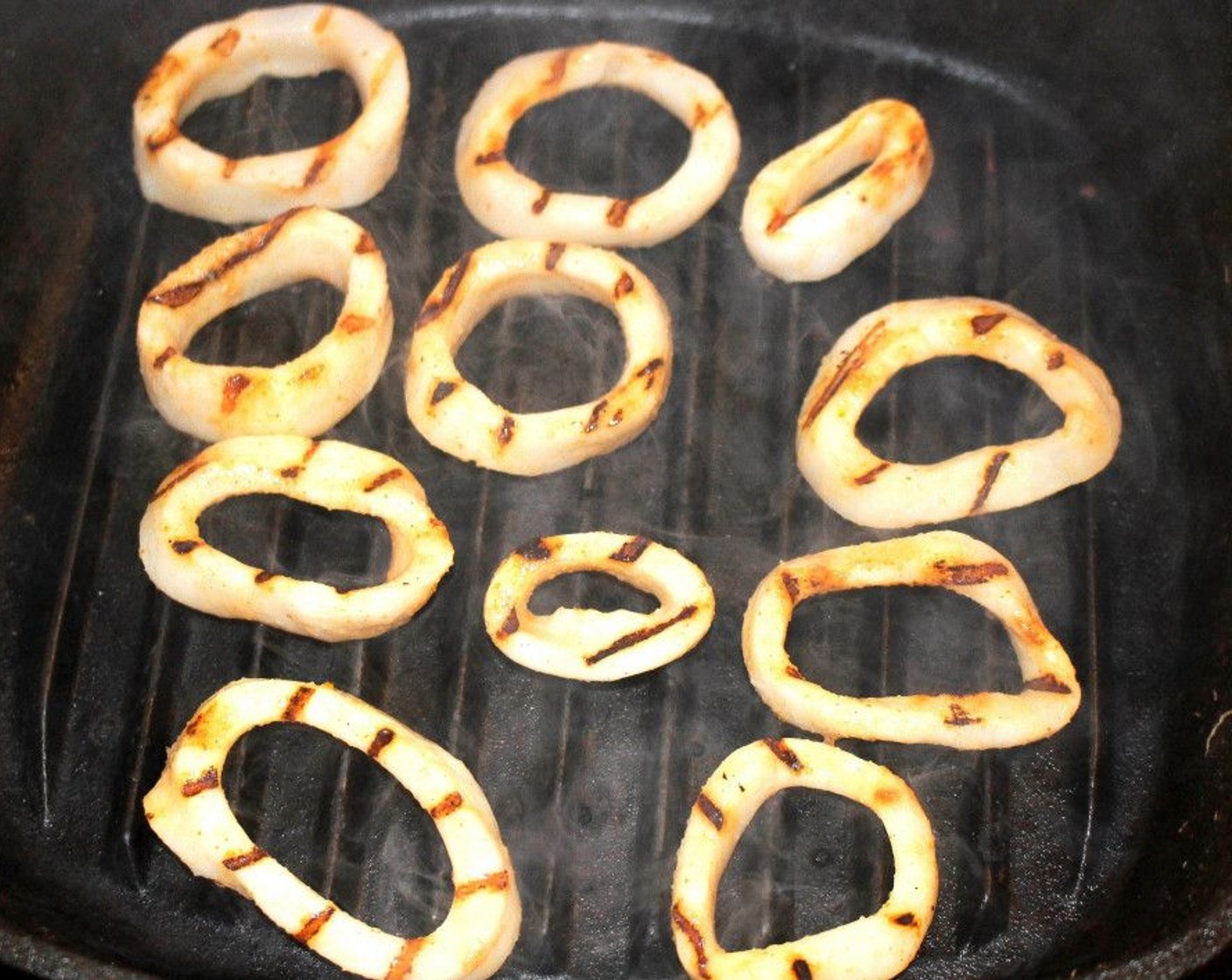 step 4 Cook the squid rings on a very hot grill pan until cooked through, about 30 seconds on each side.