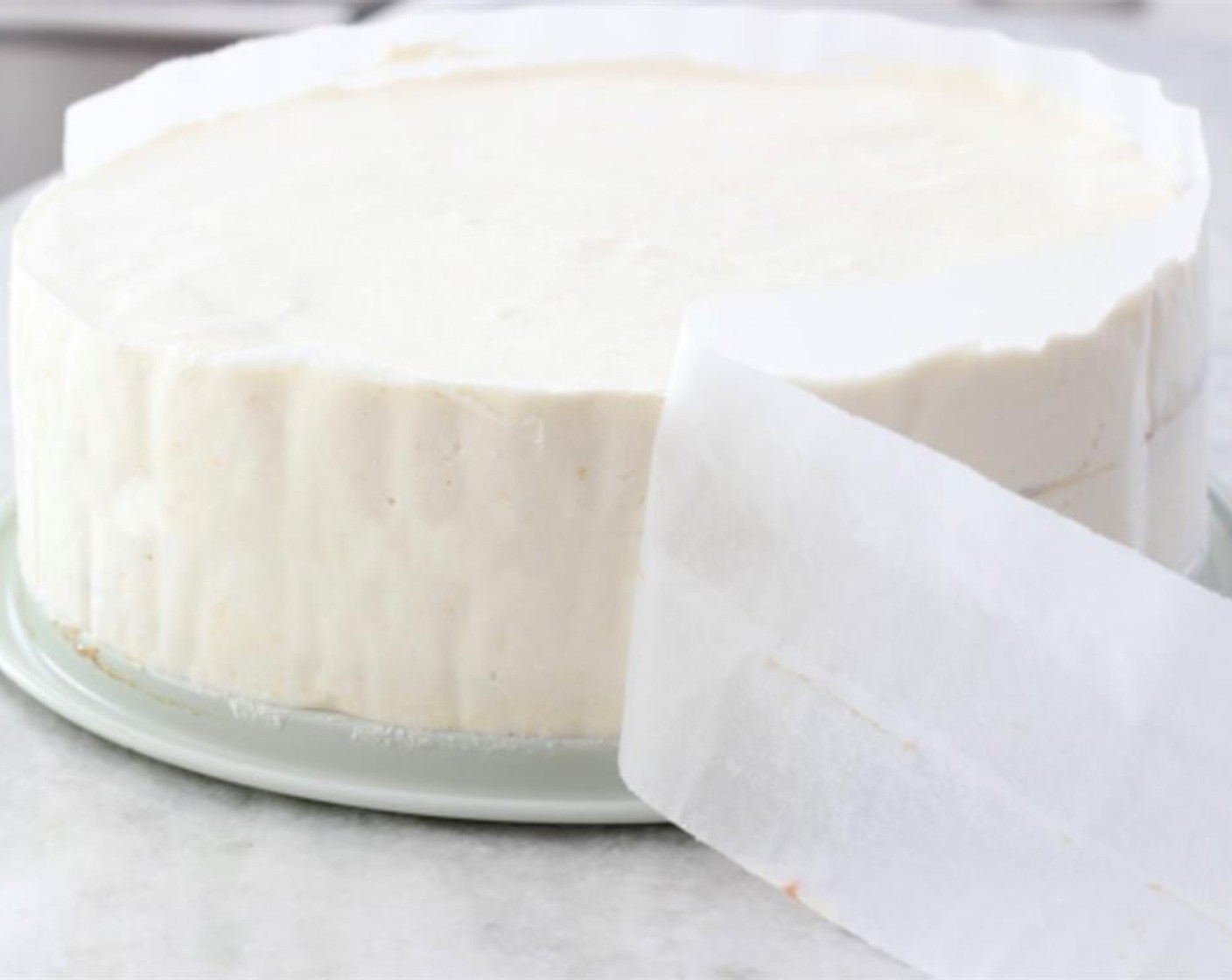 step 30 Take the cake out of the refrigerator and remove it from the springform pan. Place the cake on top of a rack and gently remove the parchment paper from the sides of the cake.