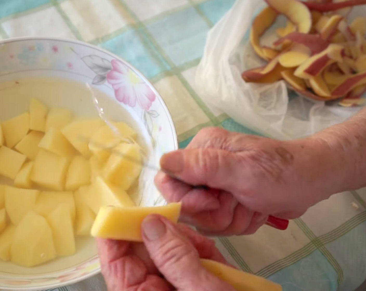 step 2 To make the roasted potatoes, peel the skin off the Potatoes (6) and cut them into your preferred size, placing them in the bowl of Water (as needed) once cut. Then, rinse and drain the potatoes once again and put them into a clean bowl.