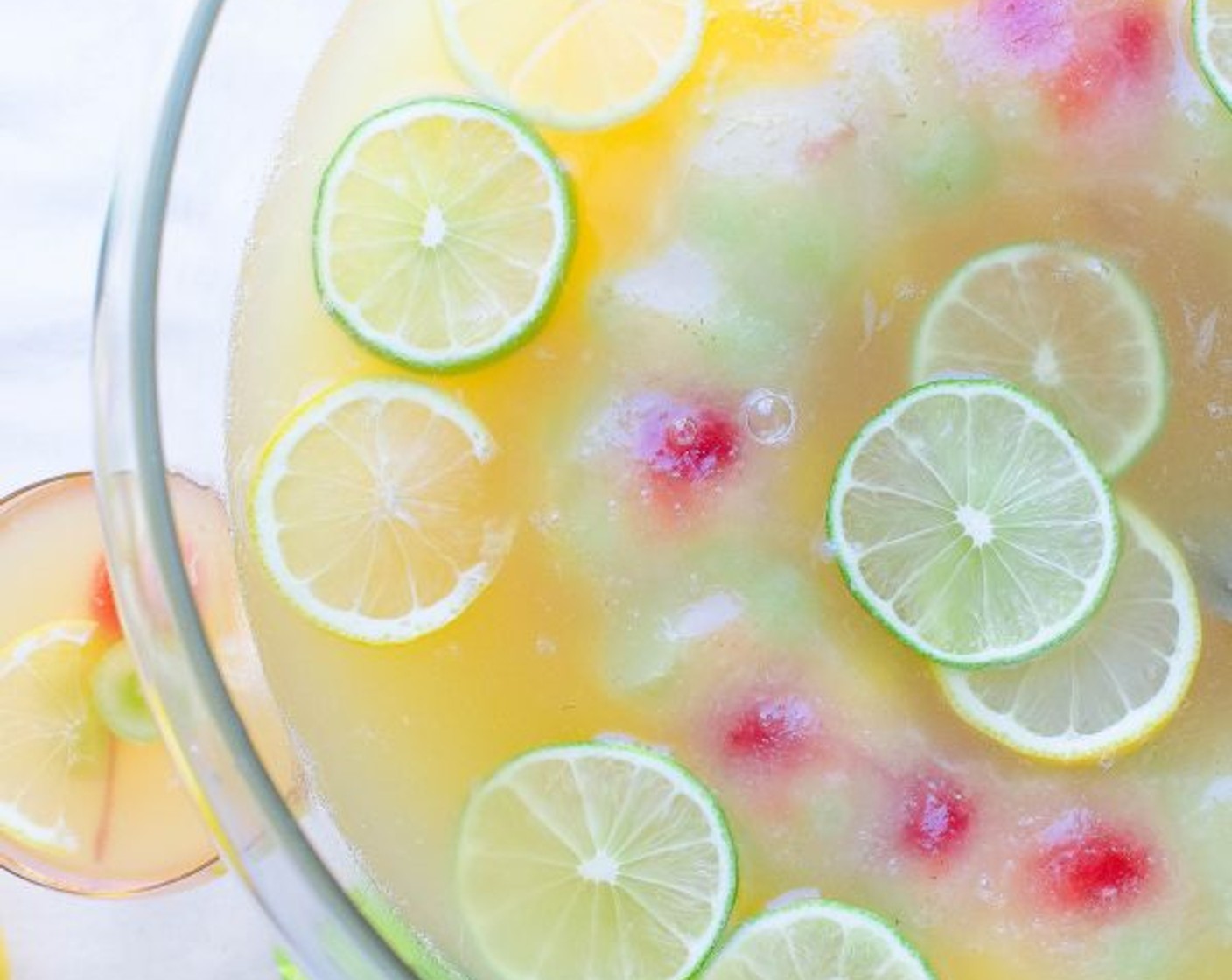 step 7 Float the ice ring in the punch bowl. Scatter slices of Lemons (to taste) and Limes (to taste) over the punch. Serve and Enjoy!