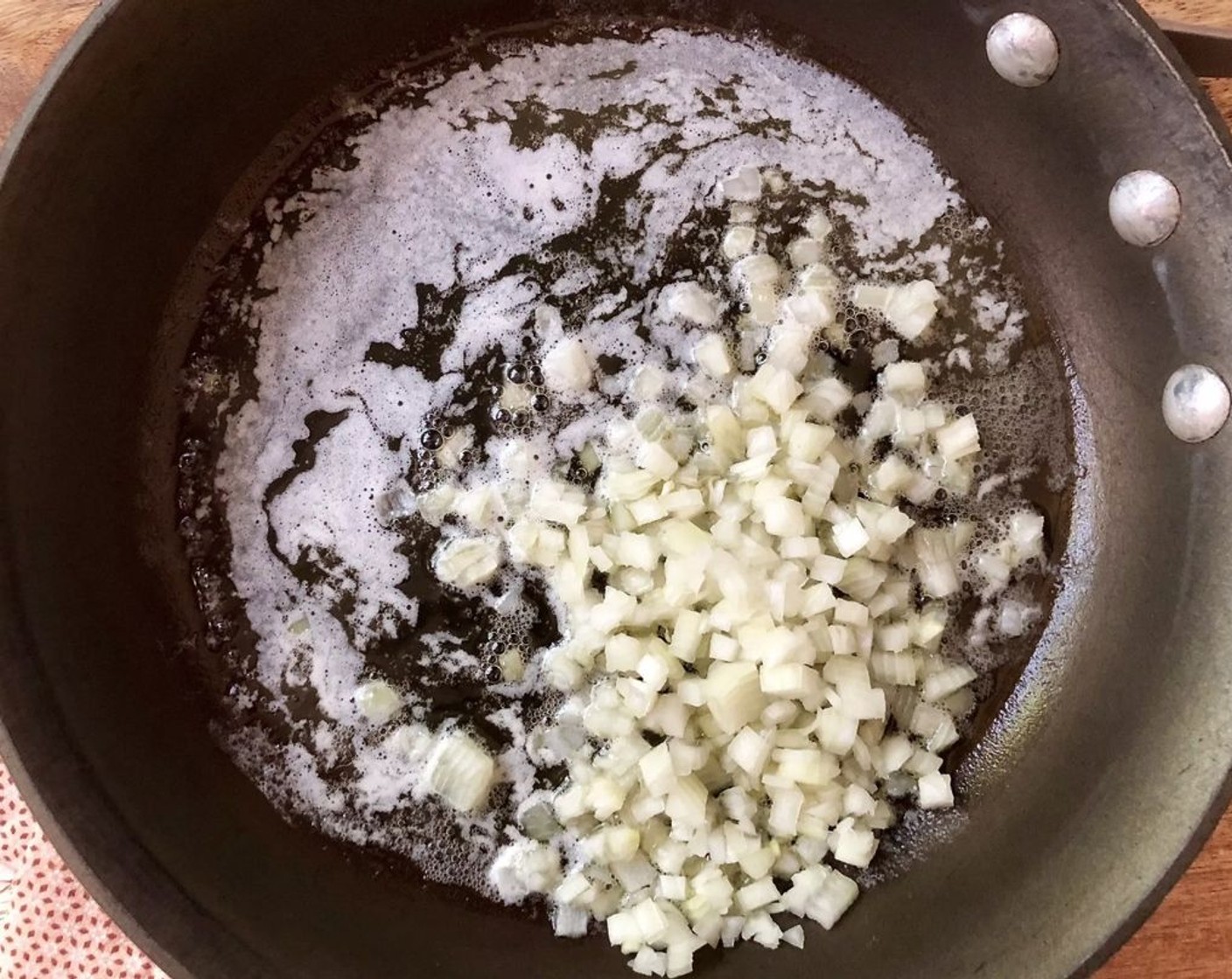 step 4 To make the white sauce, in a medium saucepan melt Unsalted Butter (1/4 cup) and cook the Onion (1) over medium heat for about 5 minutes or until softened.