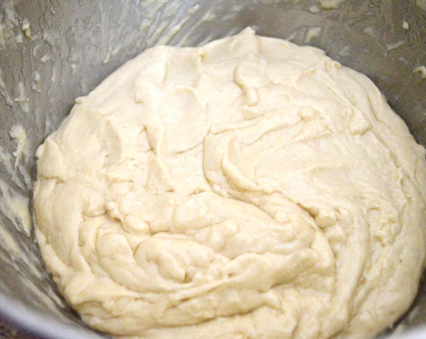 step 3 Turn the mixer on low and let the dough hook start to blend everything, pushing the sides down occasionally. Then slowly add in the remaining 3 cups of All-Purpose Flour (3 cups), a 1/2 cup at a time, until a sticky dough forms.