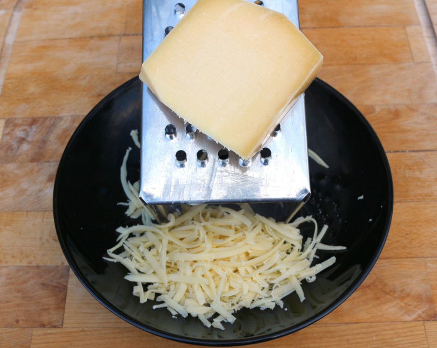 step 8 Remove the rind from Gruyère Cheese (2 3/4 cups). Add the rind to the soup and then grate the cheese.