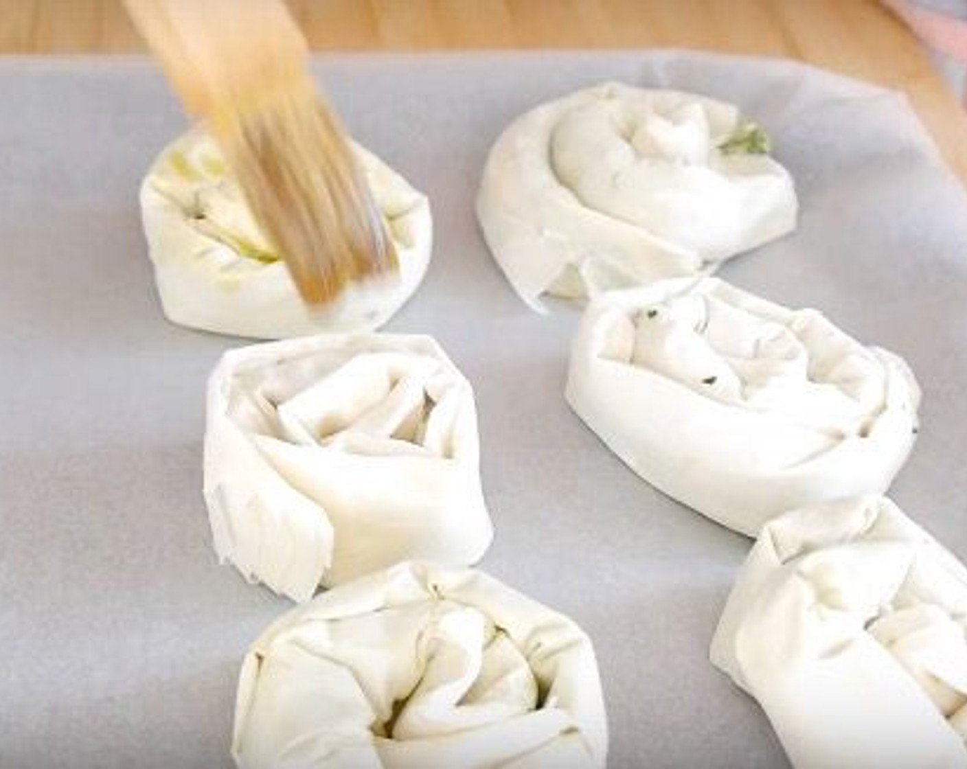 step 9 Once all the spirals are made put them on a baking sheet covered with parchment paper and brush more olive oil over each spiral.