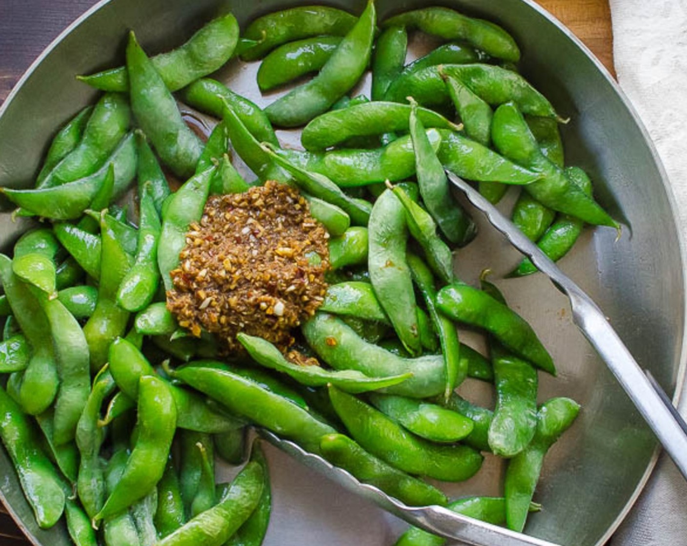 step 7 Add tamari mixture and toss to combine and continue to cook until sauce coats the edamame - no more than 2-3 minutes.