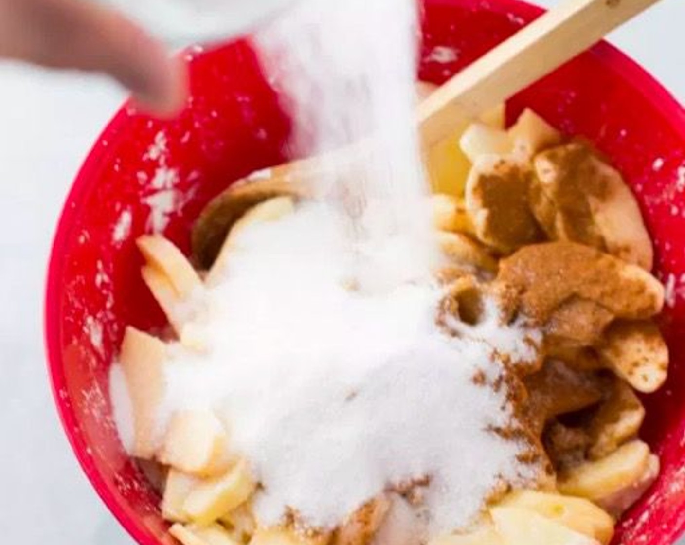 step 7 To make the pie filling, in a bowl, add Honeycrisp Apples (8 cups), Granulated Sugar (1 cup),   Brown Sugar (4 Tbsp), Corn Starch (1/3 cup), Simply Organic Cinnamon, Ground (1 tsp), Lemon (1) and Vanilla Extract (2 tsp).