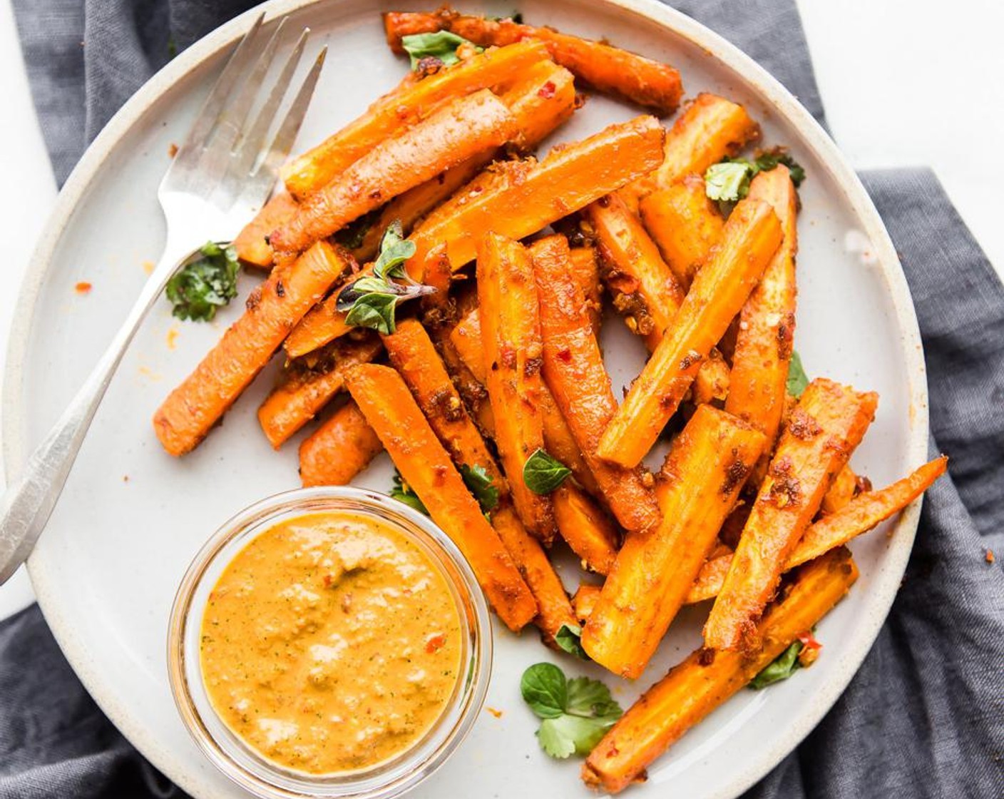 step 11 Remove from oven. Let them cool slightly or serve hot with the extra peri peri sauce or even a mayo/aioli of choice. Garnish carrot fries with extra Fresh Cilantro (to taste) and red pepper flakes if desired.