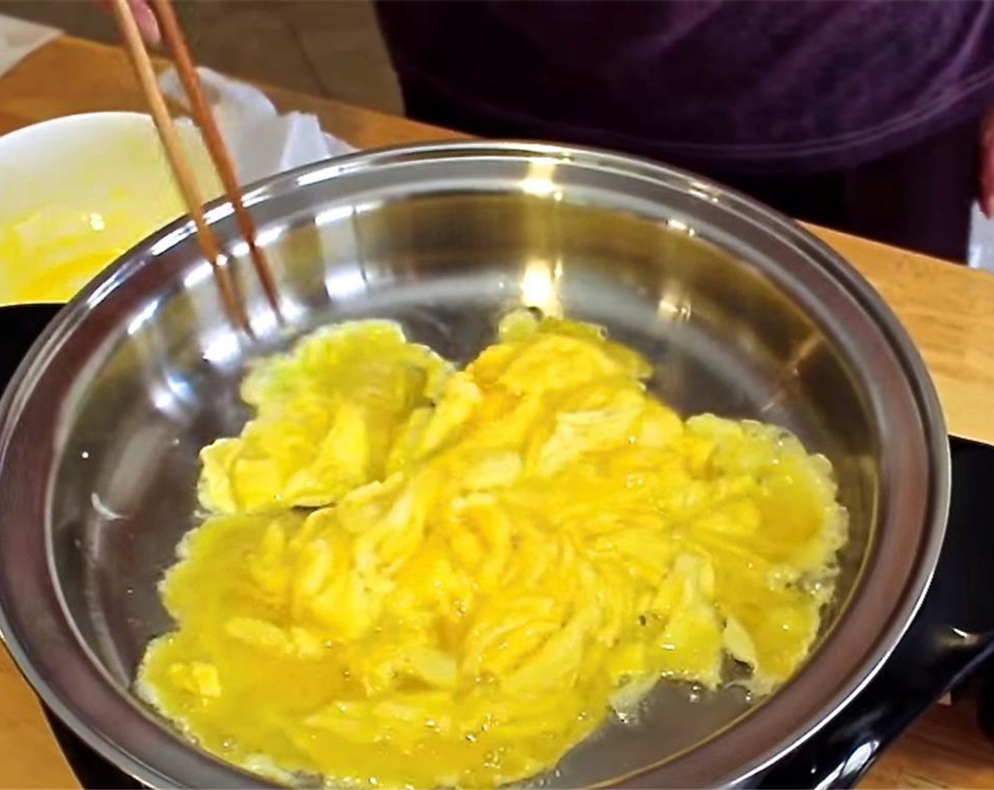 step 2 Heat Oil (1/2 Tbsp) in a frying pan. In a medium bowl, whip the Eggs (4) with the Salt (1/4 tsp) then stir-fry in the pan. Remove medium-well done eggs from the pan and set aside.