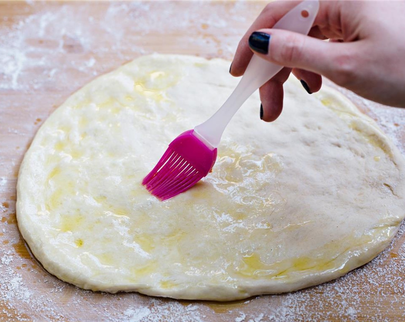 step 4 Brush half of the Extra-Virgin Olive Oil (2 Tbsp) onto the top of the pizza crust.