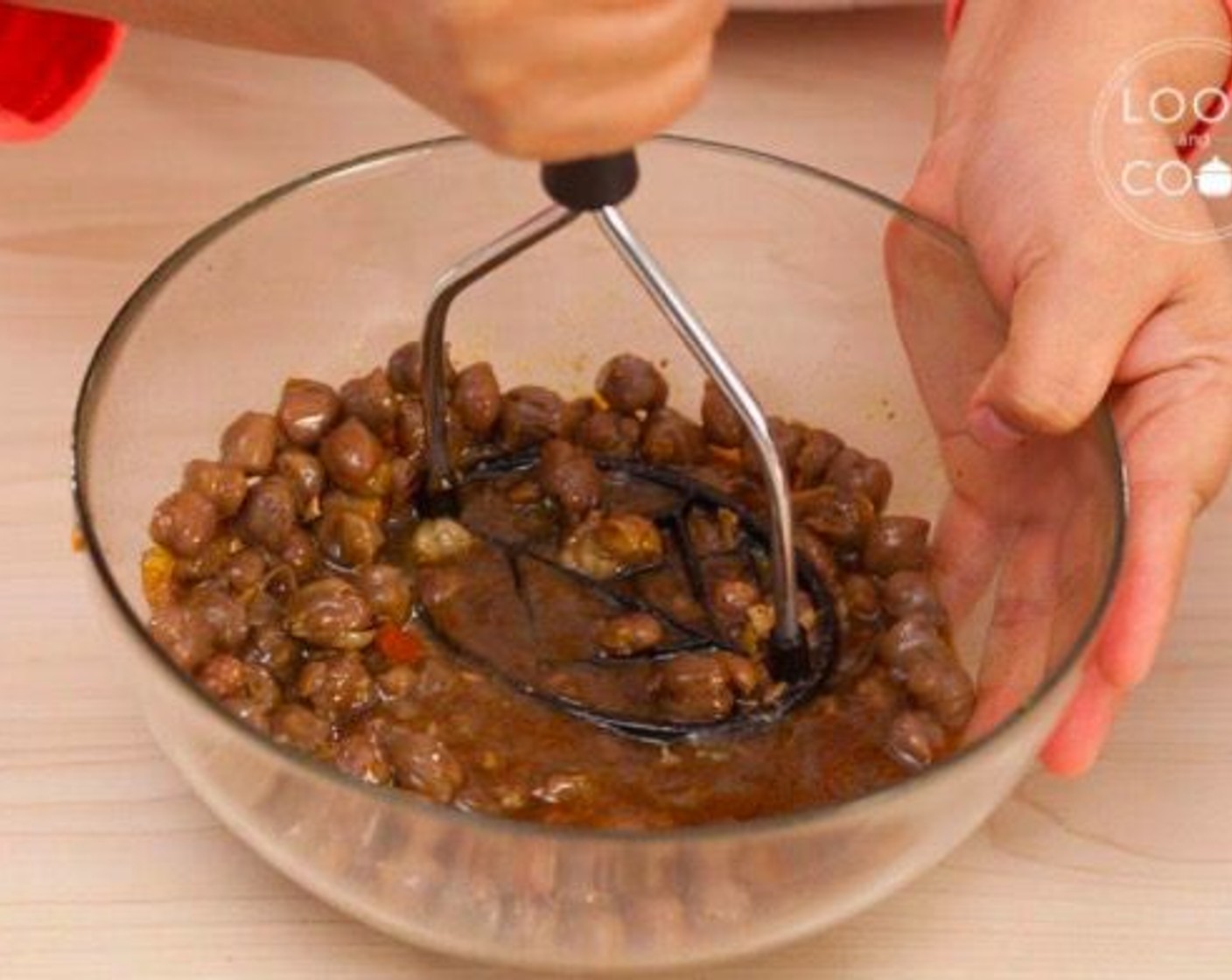 step 11 For thickening the gravy,  take half of the chickpeas to a bowl, mash with a potato masher (or with the back or a spoon)