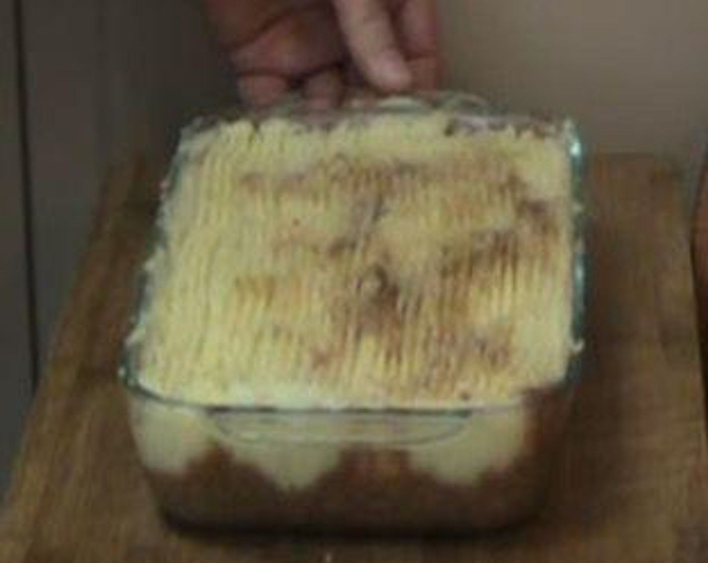 step 4 Add Butter (1 Tbsp) and Parmesan Cheese (to taste) to Potato (1 lb). Top the shepherds pie with the potatoes and score with a fork.