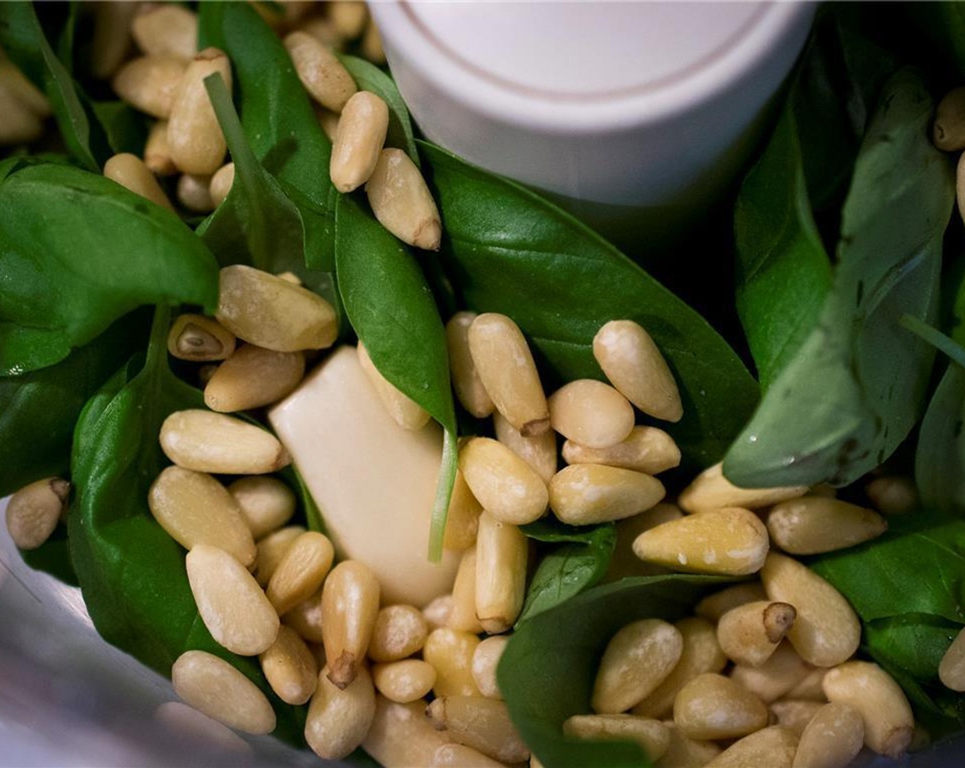 step 3 To make the pesto. Add to the bowl of a food processor, the Fresh Basil Leaves (2 cups), Garlic (2 cloves), Pine Nuts (1/4 cup), and Parmesan Cheese (1/2 cup). Pulse while slowly adding Olive Oil (1/2 cup) until smooth and desired consistency. Add the Kosher Salt (1/2 tsp) and Ground Black Pepper (1/8 tsp) and pulse a few more times to incorporate.