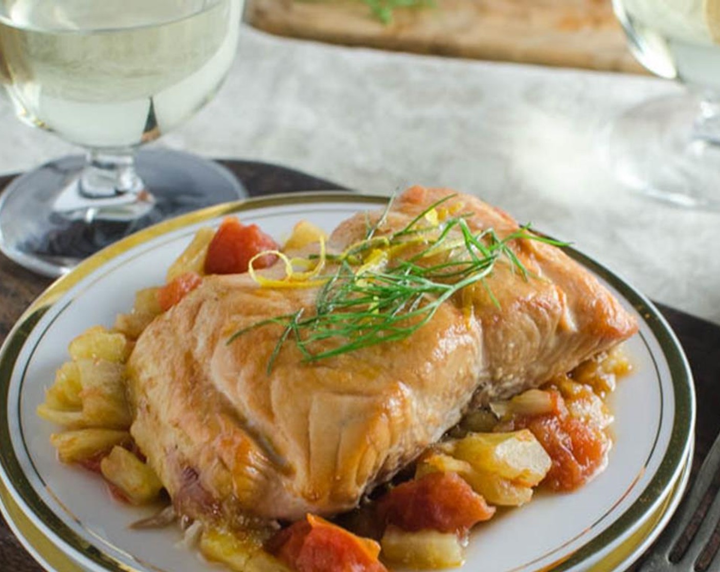 step 7 To serve: Cut salmon into 2" thick slices (skin will stick to the plank leaving you with a nice fillet) and place on a plate. Top with a generous spoonful of fennel mixture. Garnish with fennel fronds.