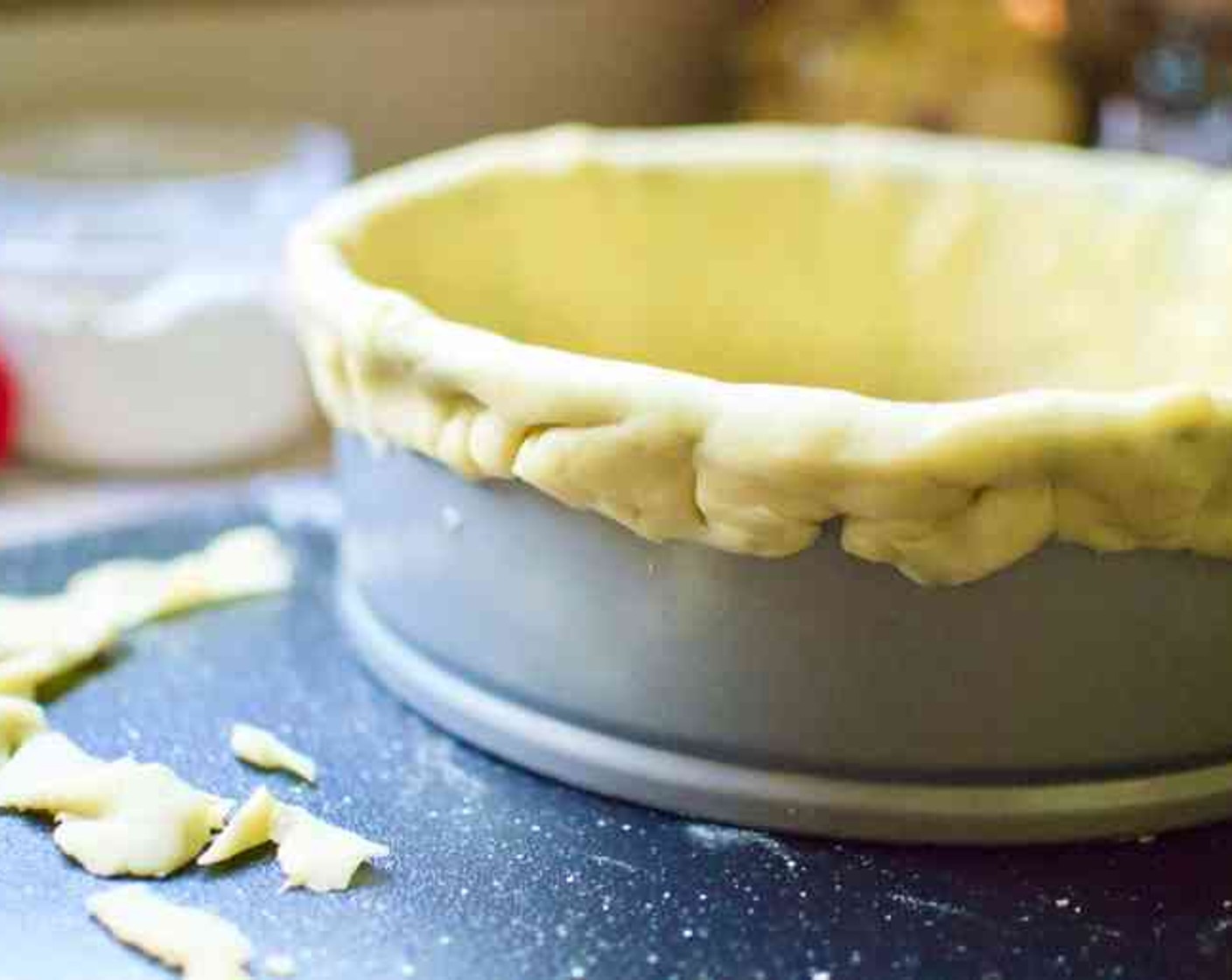 step 5 Trim the overhanging pastry to 1-inch and press it firmly against the outside of the ring to help prevent it from shrinking. Use the trimmings to fill any cracks. Freeze the shell for 20 minutes.