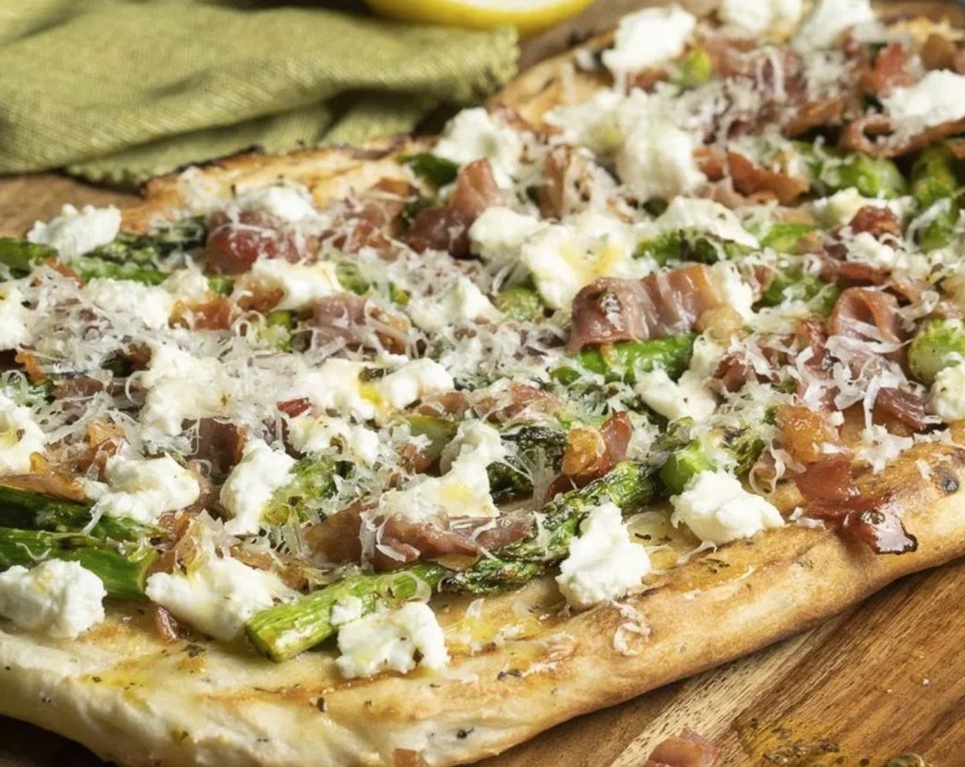step 14 Immediately scatter on half of the asparagus, prosciutto, and Goat Cheese (1/3 cup). Sprinkle with Grated Grated Parmesan Cheese (4 Tbsp) and close the lid. Allow to cook for 3-4 more minutes to warm toppings and finish cooking the dough.