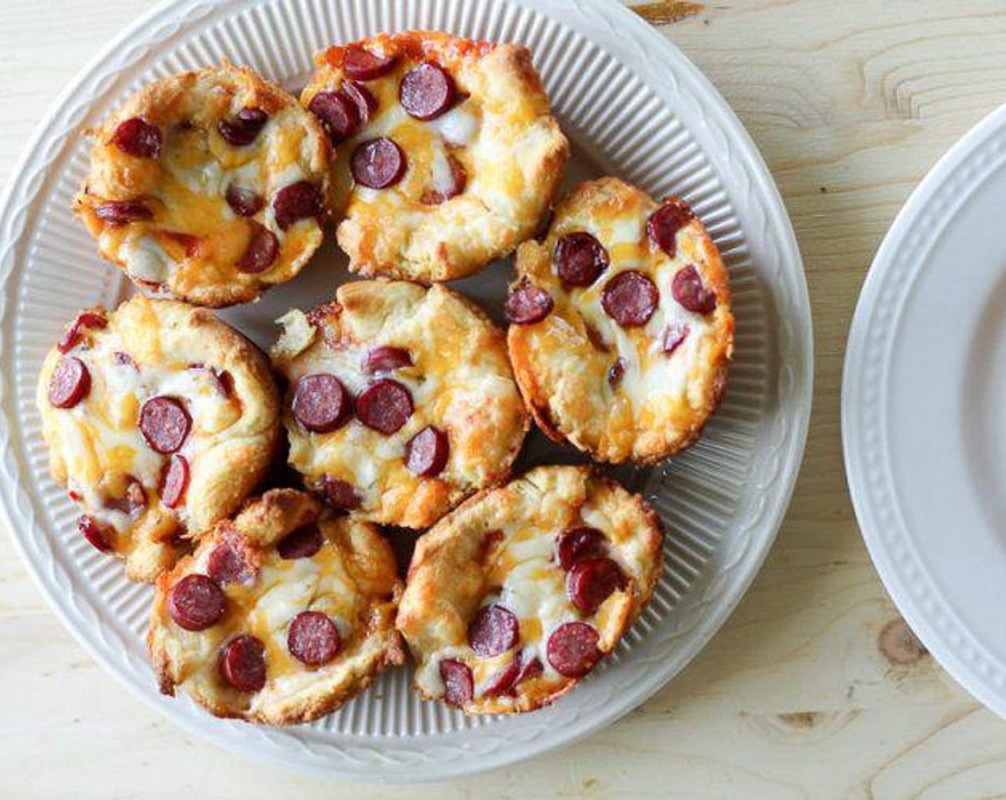 step 5 Cool for 1 minute in the muffin pan. Gently move a knife around the edge of each pizza cup to release them from the pan. Serve warm.