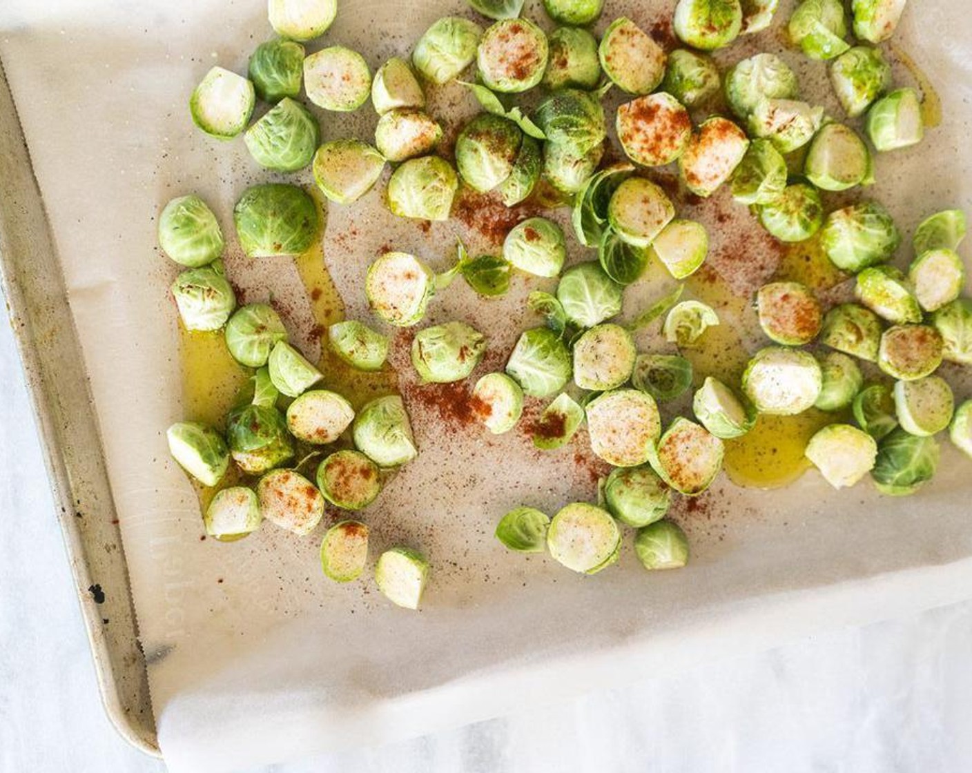 step 3 On a large baking sheet, toss Brussels sprouts in Olive Oil (1/4 cup) and season with Salt (to taste), Ground Black Pepper (to taste), Smoked Paprika (1/2 tsp), and Cayenne Pepper (1/2 tsp).