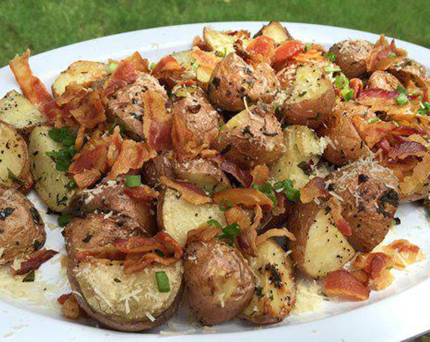 step 4 Once your roasted potatoes are off the smoker, put them on a serving platter and garnish with Grated Parmesan Cheese (1 cup) and crumbled bacon. These Parmesan Garlic Smoked Potatoes will the star of dinner.
