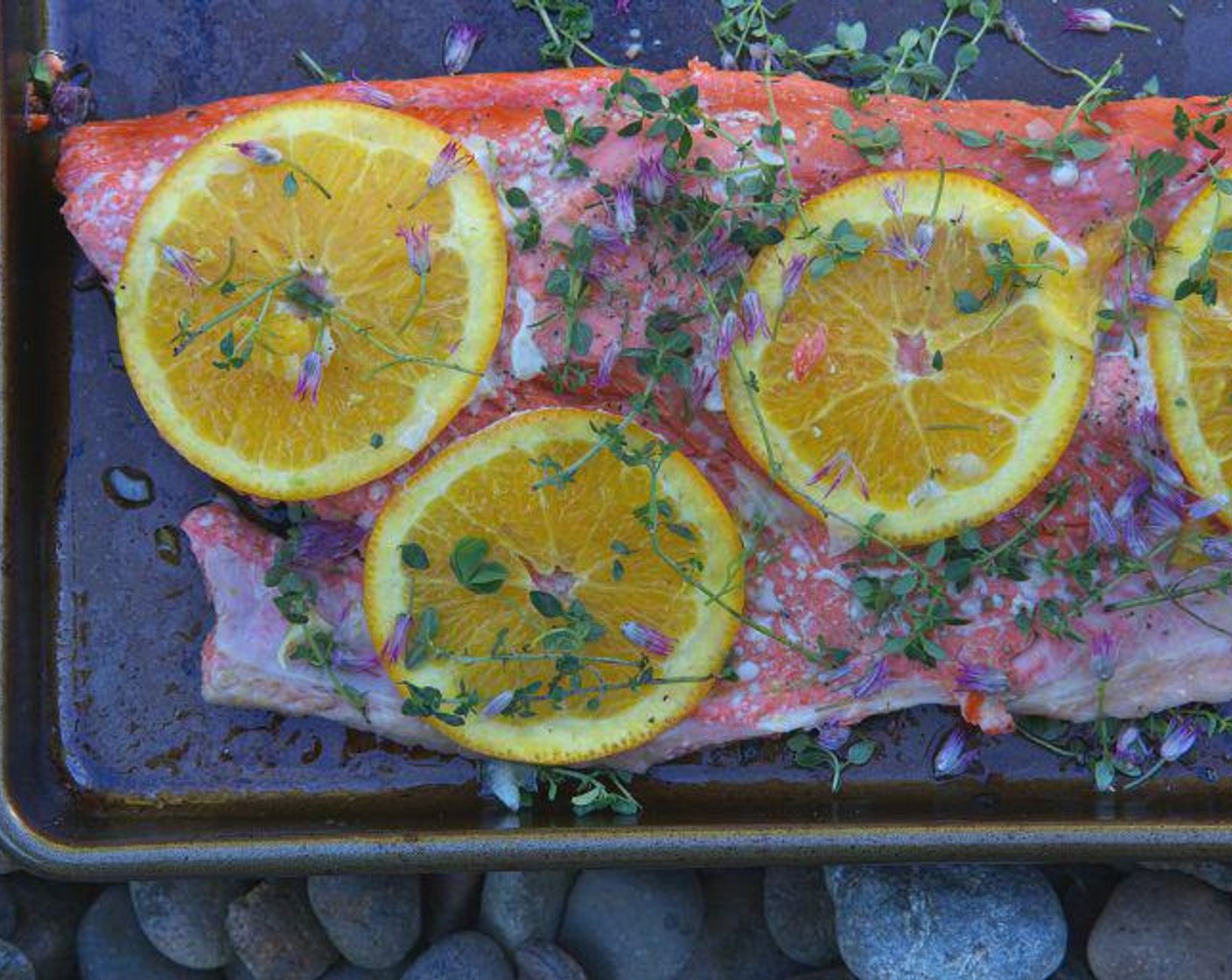 step 4 Season your Copper River Sockeye Salmon (1.5 lb) with Salt (to taste) and Ground Black Pepper (to taste). Top with your orange slices and Fresh Lemon Thyme Leaves (1 bunch). Flip your salmon onto your baking sheet so it is skin-side up with the orange slices under the salmon.