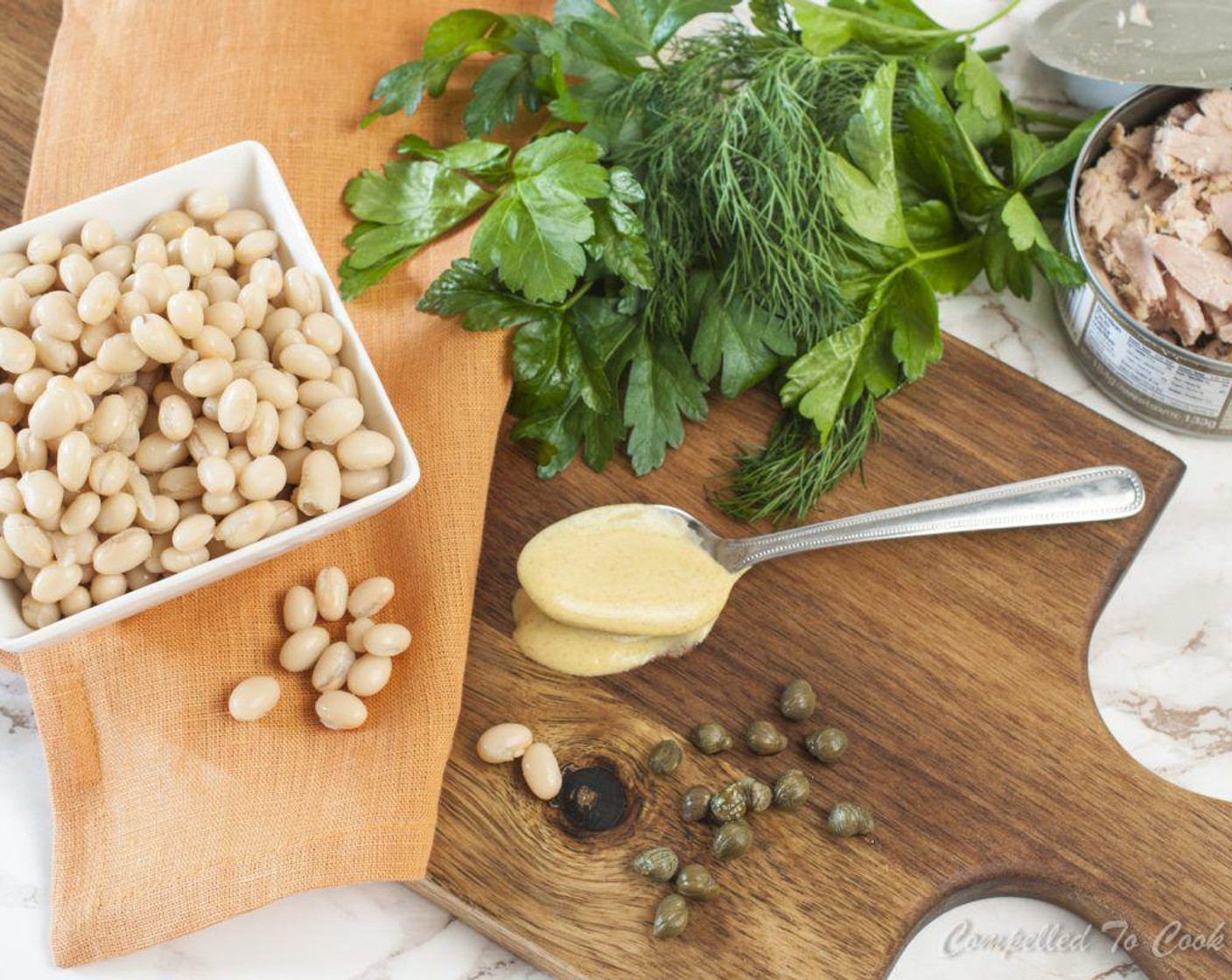 step 1 In a medium-size bowl, stir together Mayonnaise (1/4 cup), Sour Cream (1 Tbsp), Dijon Mustard (1 Tbsp), Shallots (3), Capers (2 Tbsp), Celery (1 stalk), Fresh Dill (1 Tbsp), Fresh Parsley (1 Tbsp), Salt (1 pinch), and Ground Black Pepper (1 pinch).