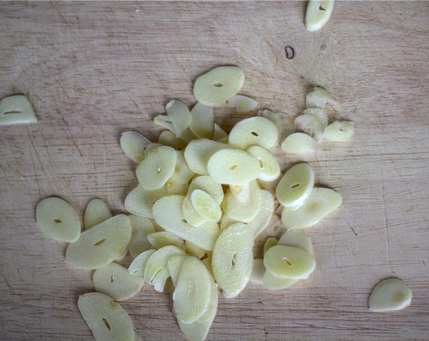 step 2 Using a mandolin or a sharp knife, thinly slice the Garlic (5 cloves). You want about the thickness of a dime, about 1 millimeter