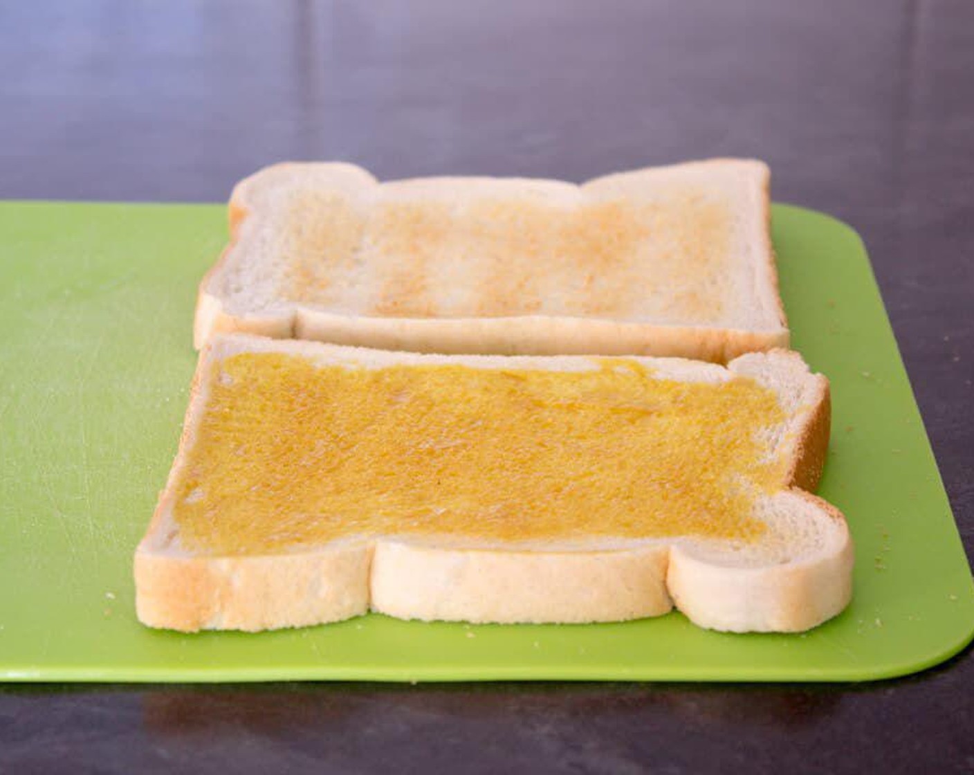 step 6 Spread a thin layer of Honey Mustard (to taste) onto one slice of bread.