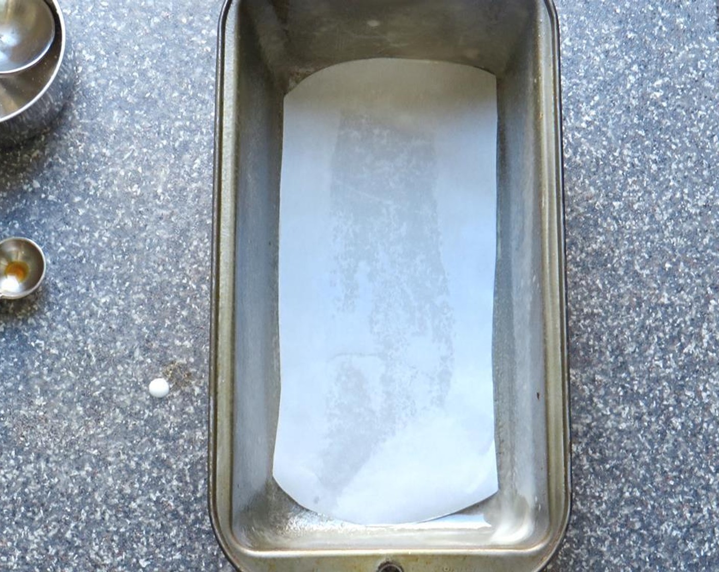 step 2 Cut a piece of parchment paper to fit the bottom of the pan. Spray a loaf pan (8 1/2" x 4 1/2" x 2 1/2") liberally with non-stick vegetable spray. Place parchment paper in the bottom of the pan and spray again.