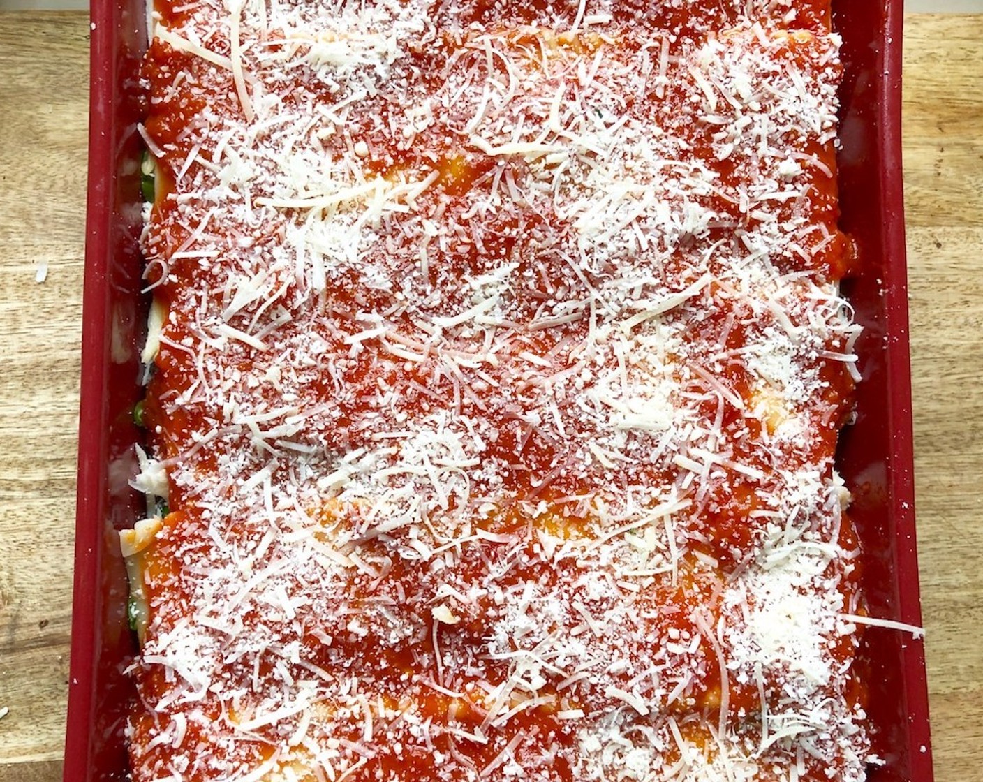 step 15 Repeat with another layer of noodles, vegetables, cheeses, and sauce, followed by a finishing layer of noodles. Top them off with the remaining sauce and parmesan cheese.