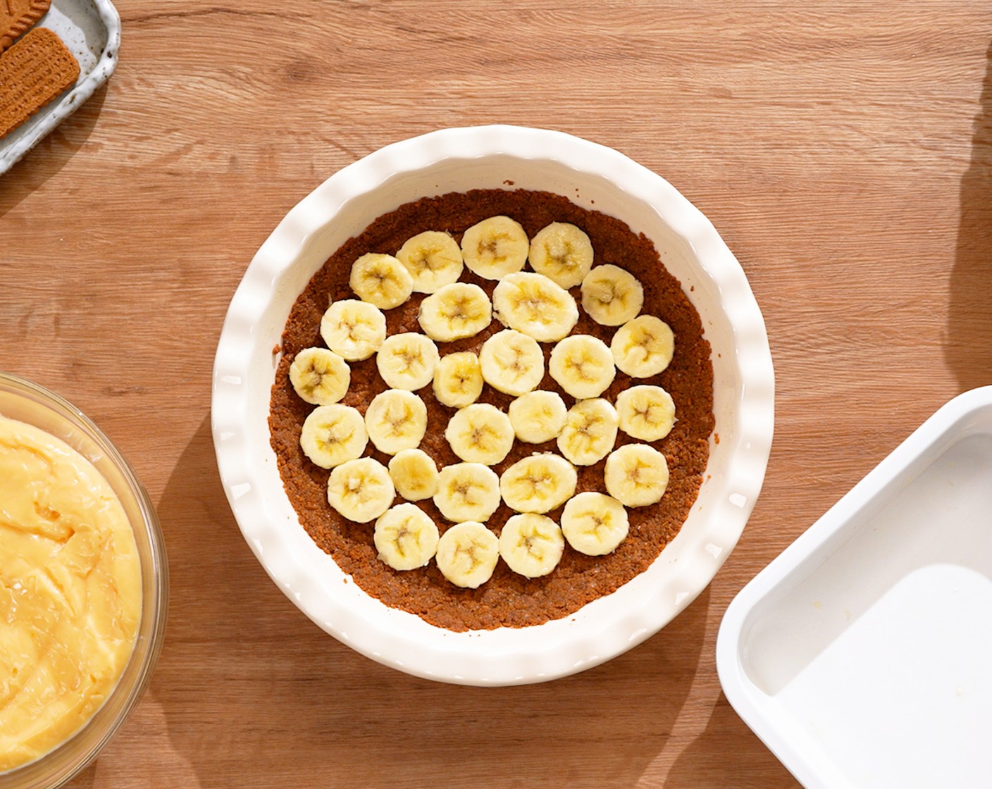 step 10 To assemble the pie, first arrange about ⅔ of the Bananas (3) over the crust. Then spread the filling on top of the banana slices in an even layer. Refrigerate until the filling is cooled completely, about 20 minutes.